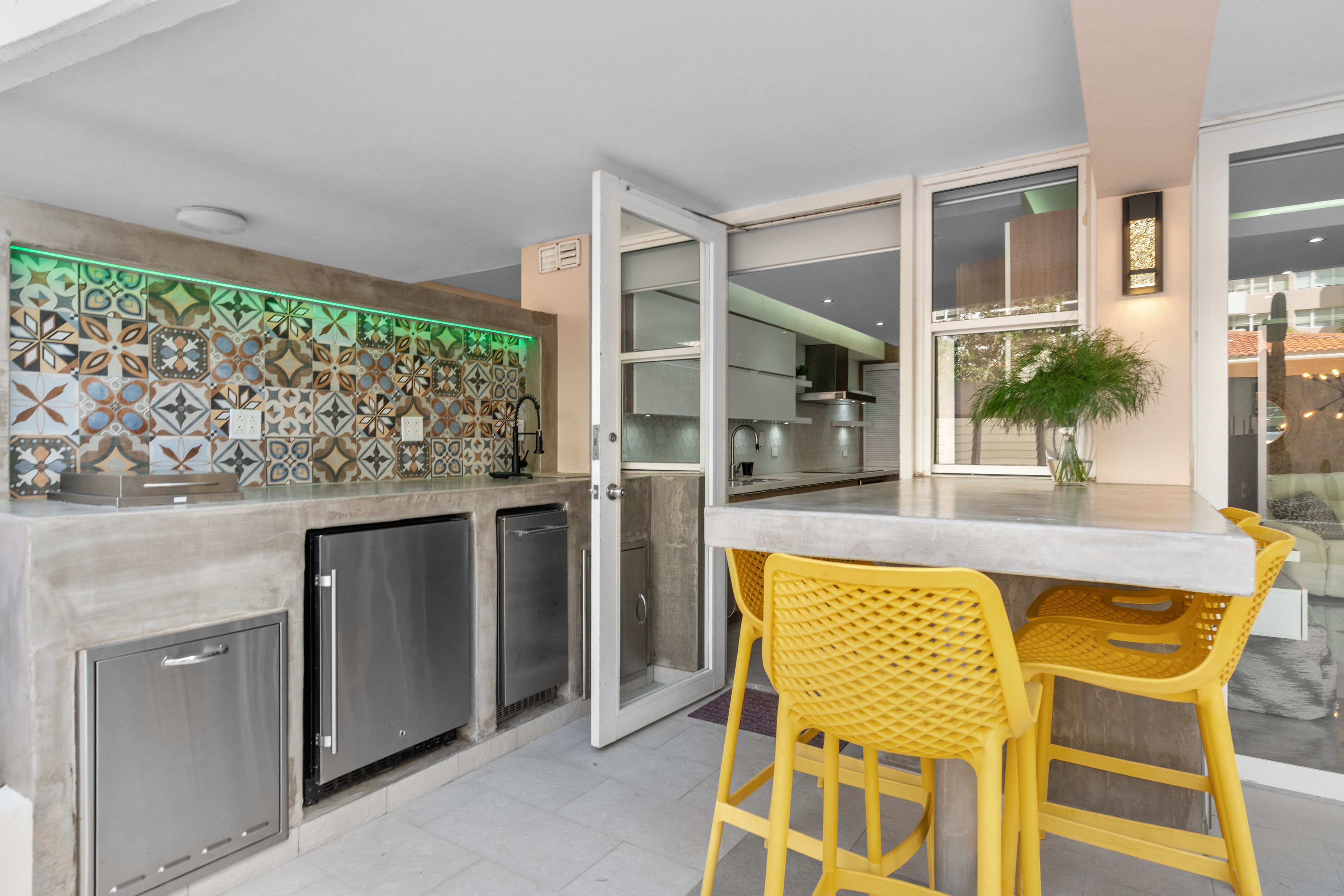 Astralis Residences outdoor terrace with built-in BBQ and bar seating area