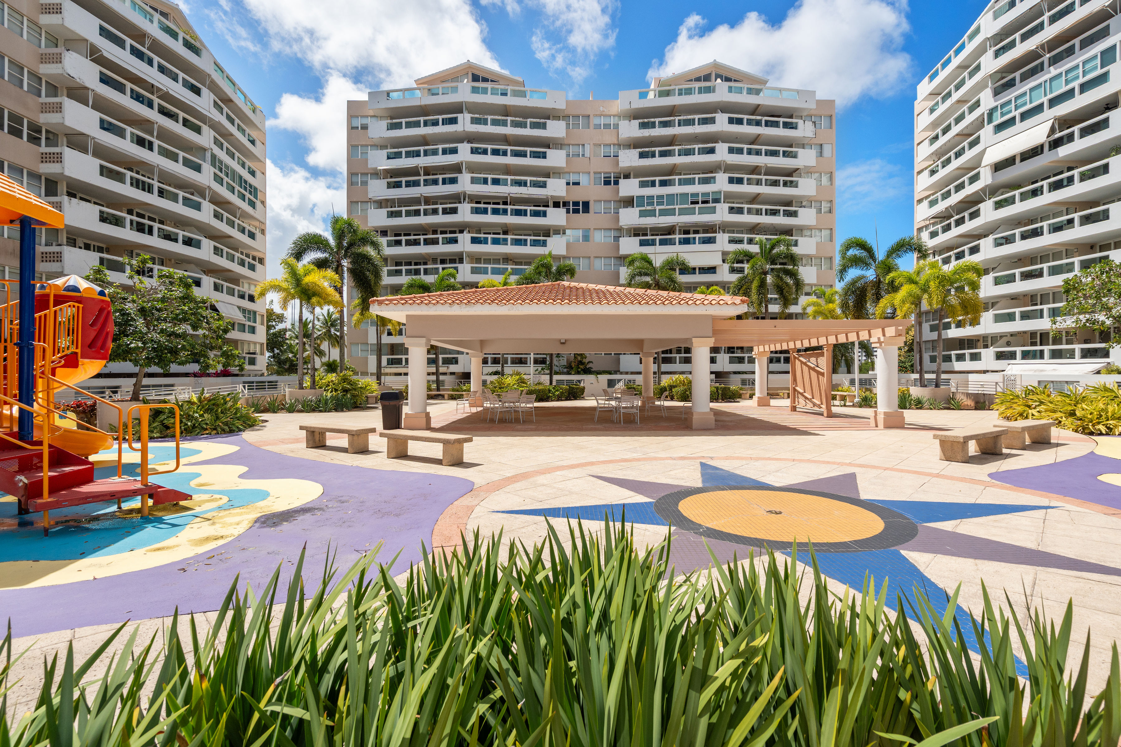 Astralis Residences outdoor gazebo seating area with playground and landscaped courtyard