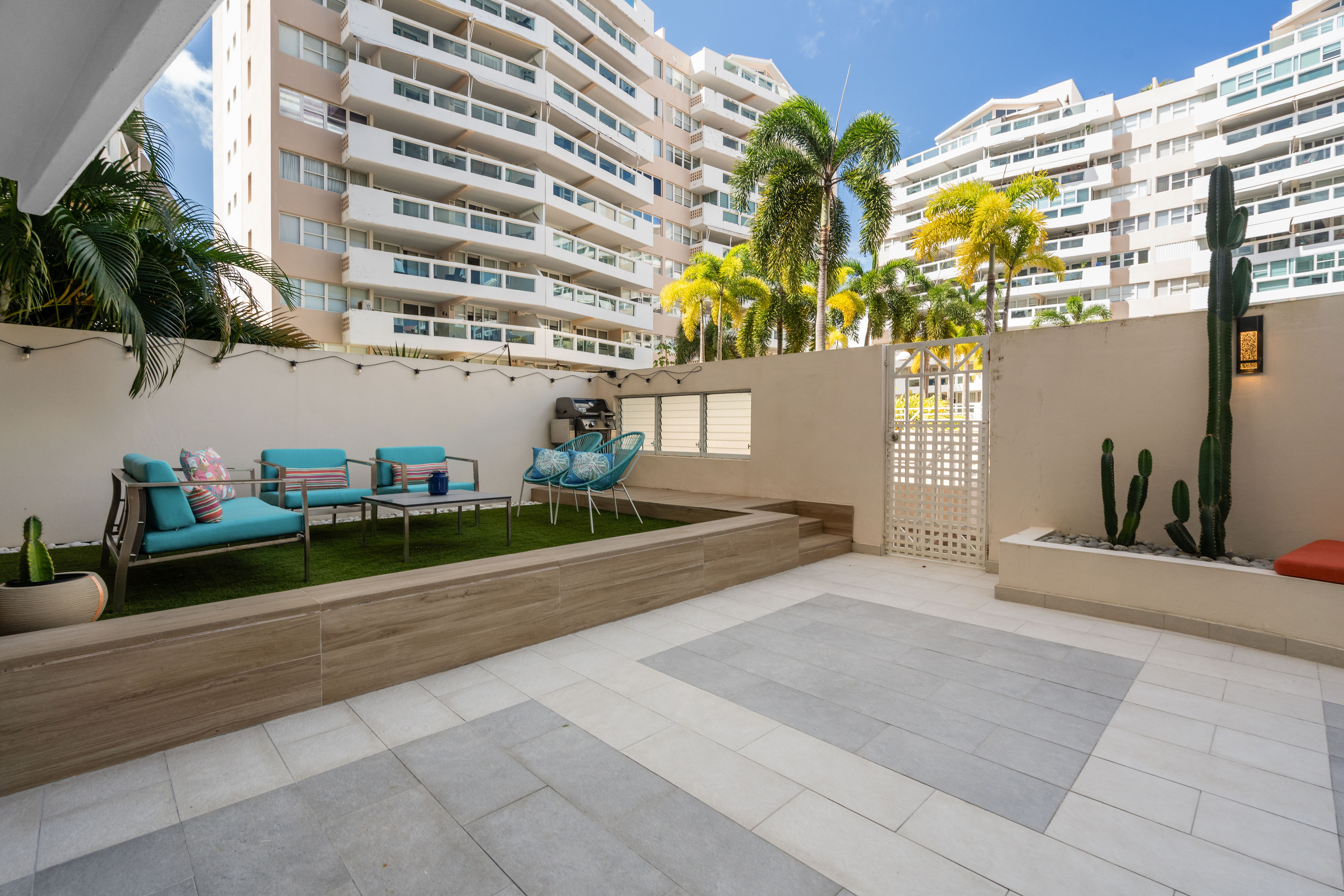 Astralis Isla Verde private patio with lounge seating and landscaped outdoor space