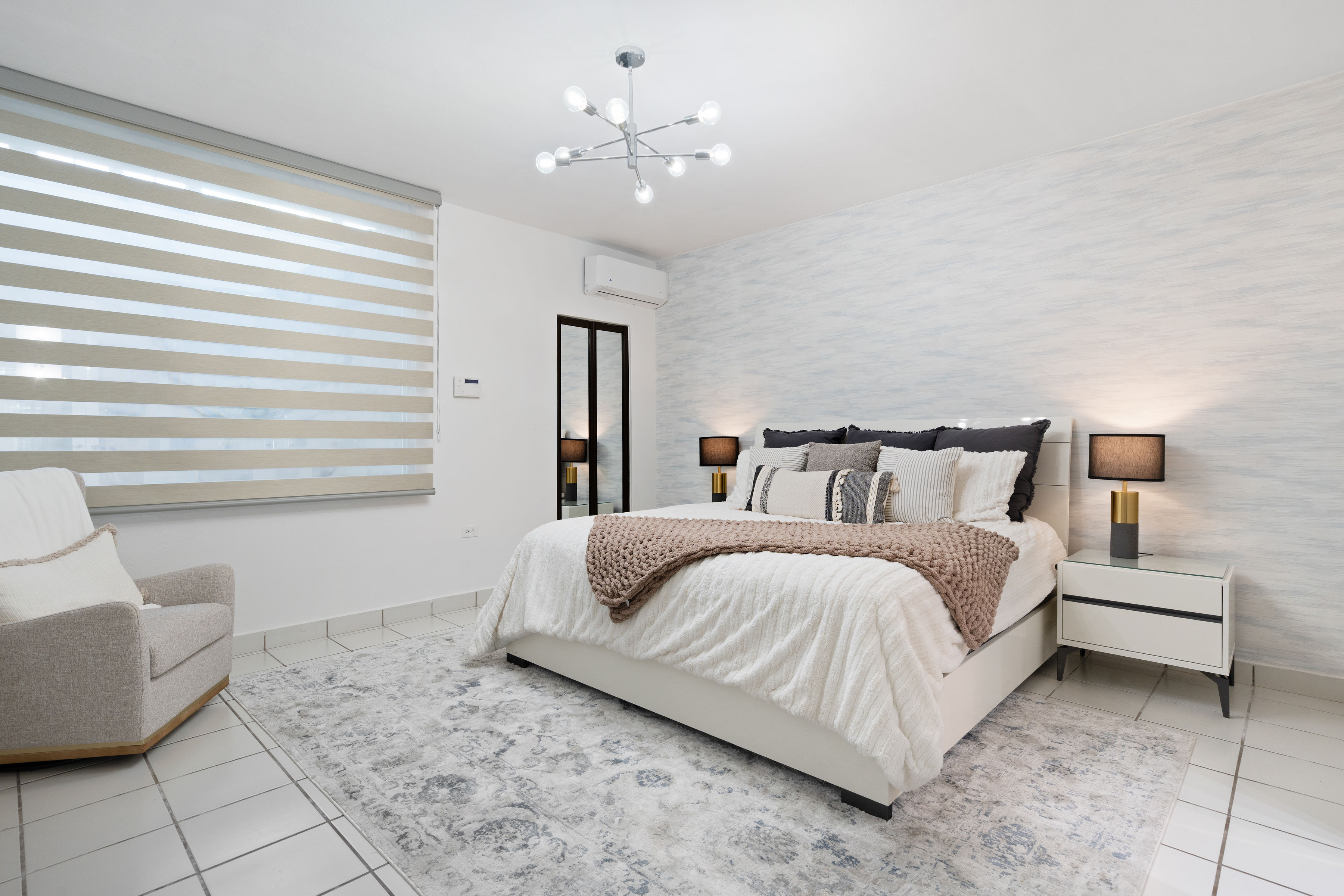 Primary bedroom with modern design, natural light and neutral tones in San Juan home