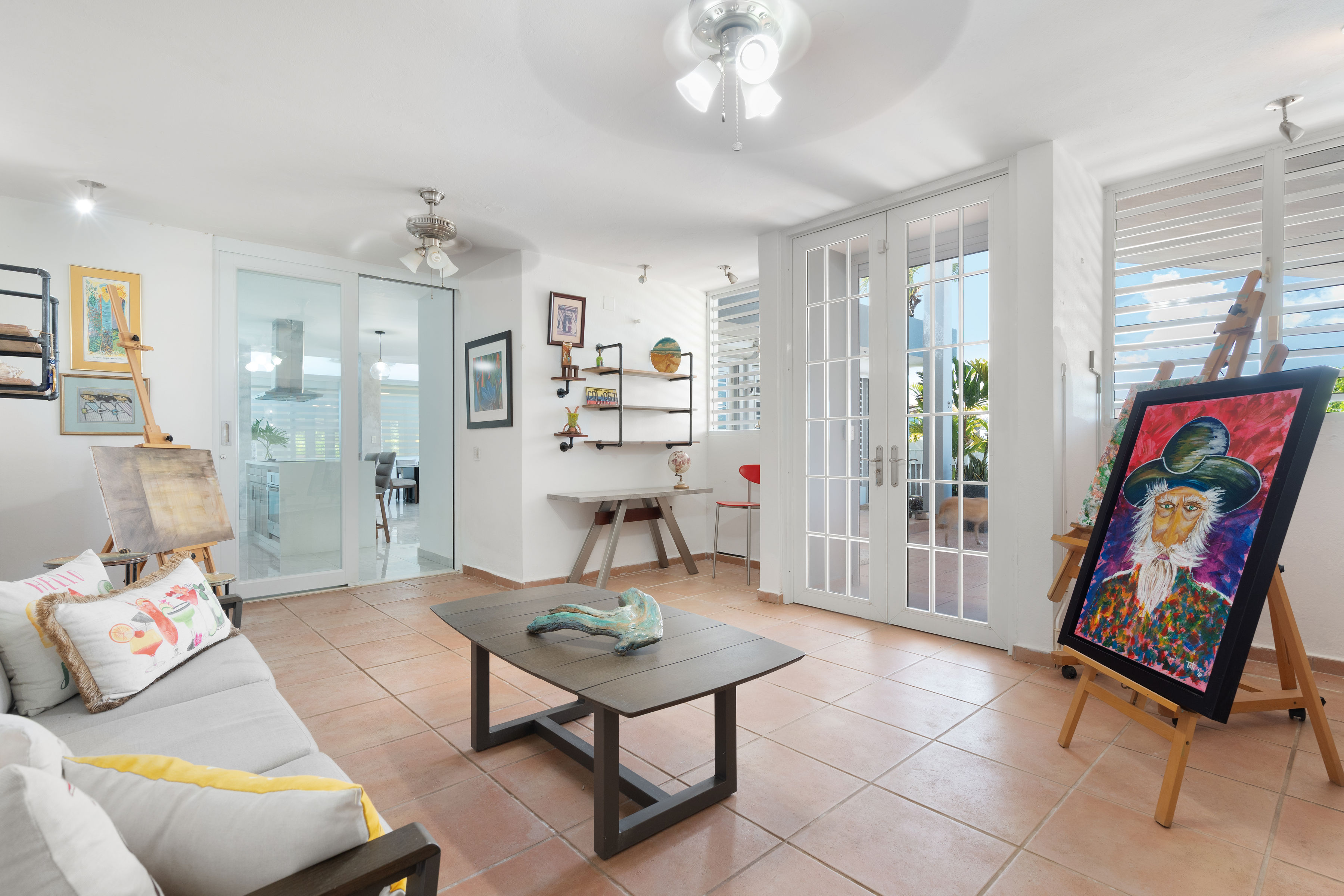 Flexible bonus room with seating area, art display and terrace access in Mansiones de Villanova home