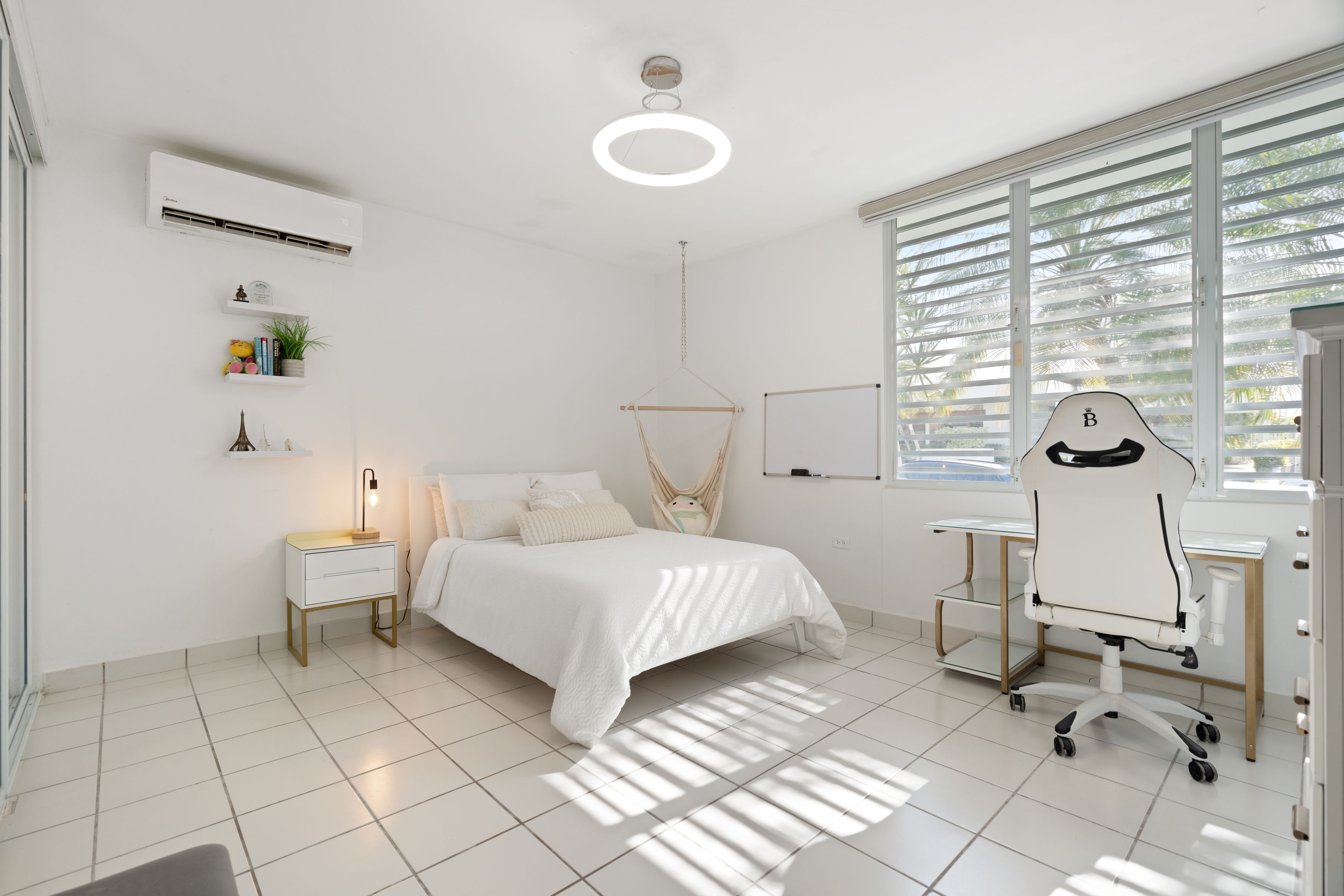 Bright bedroom with workspace, large windows and natural light in San Juan home