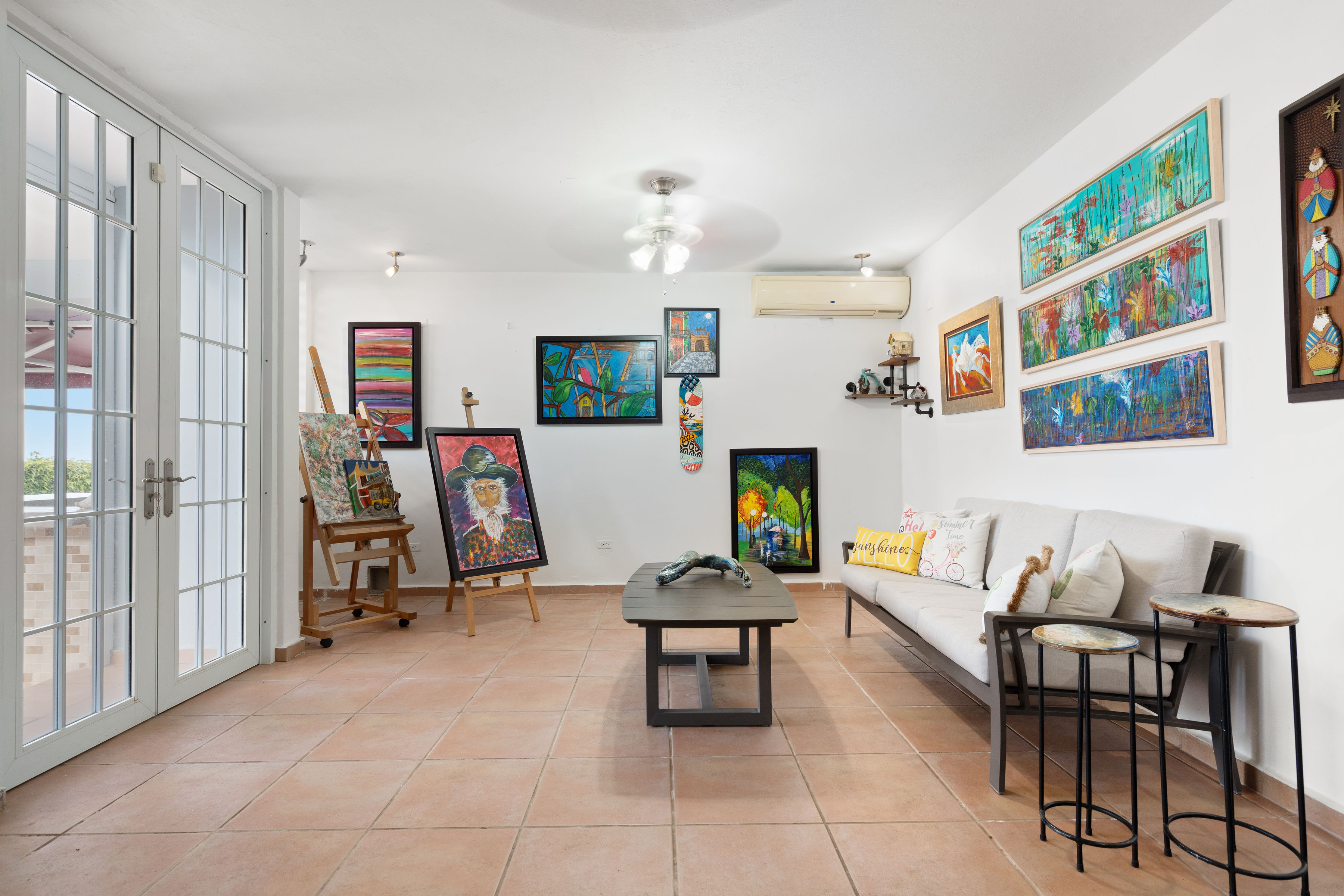 Flexible bonus room with art studio setup and outdoor access in Mansiones de Villanova property