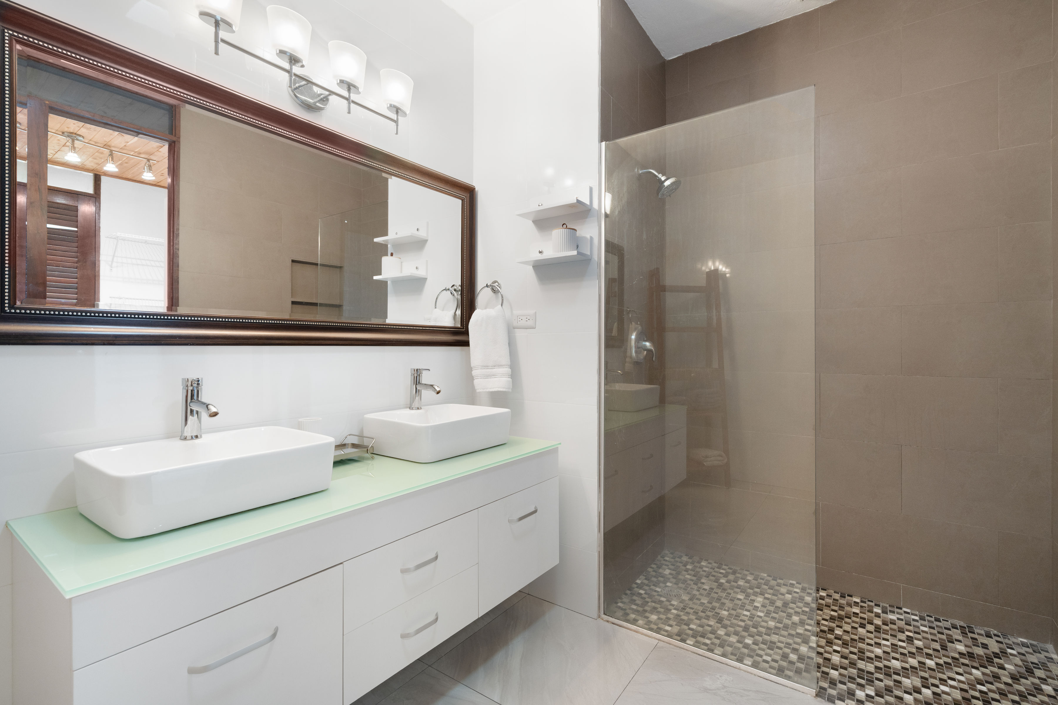 Bathroom with double vanity, walk in shower and modern finishes in San Juan Puerto Rico home