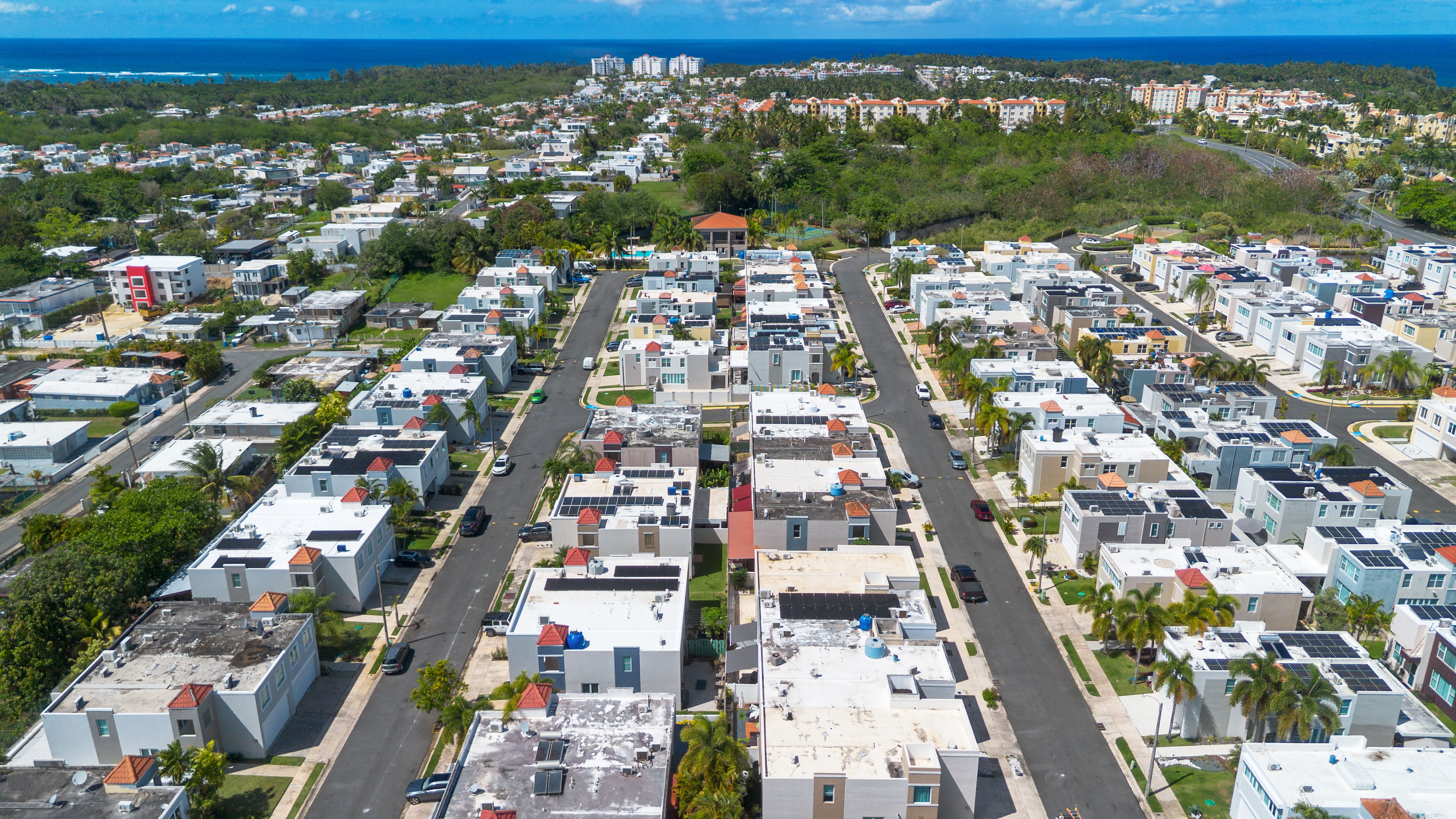 Aerial view of Cielo Dorado Village community with organized streets and proximity to coastal area
