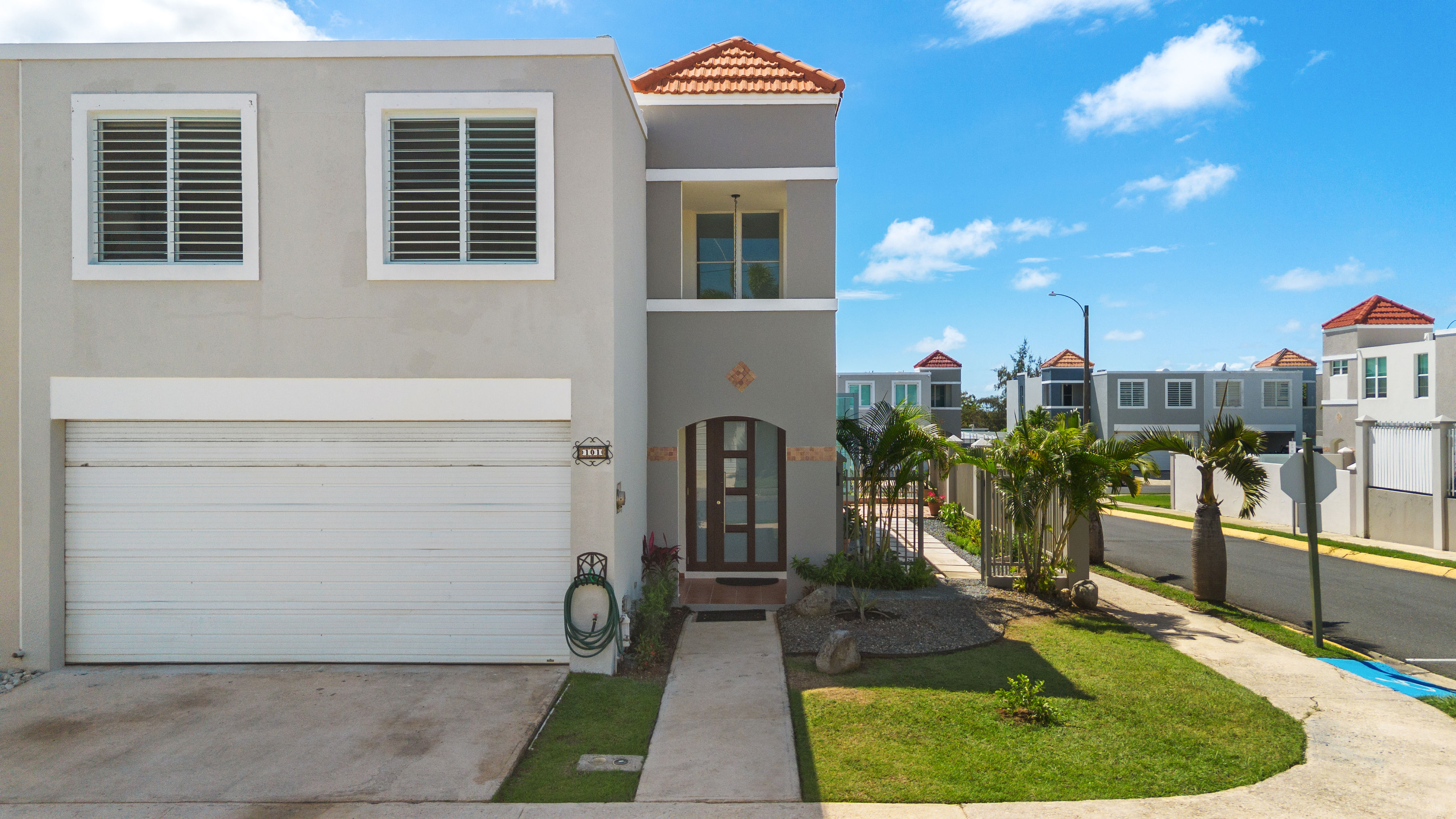 Front exterior of two-story residence in Cielo Dorado Village with garage, landscaped entrance, and corner lot positioning