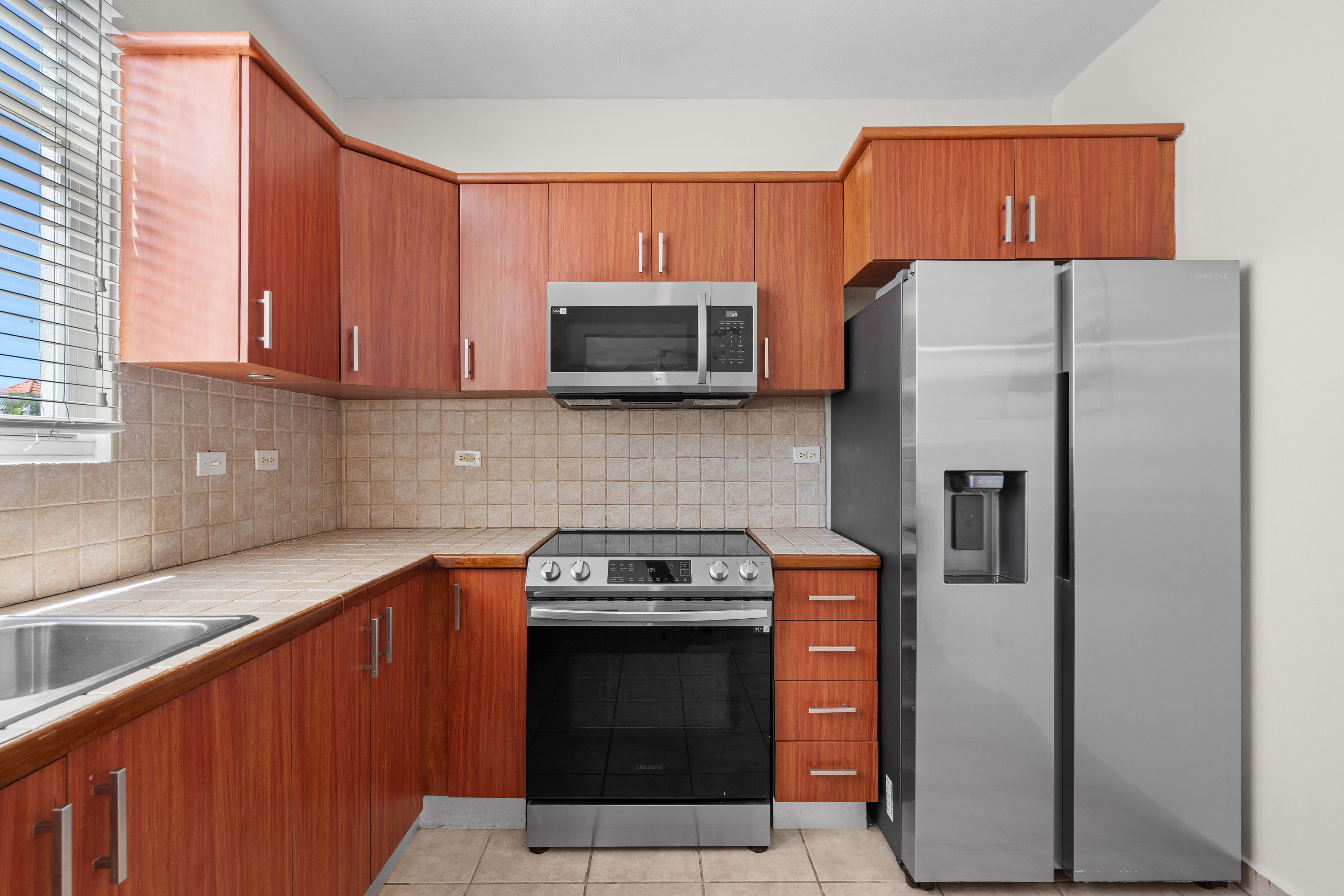 Kitchen view showcasing open concept design with direct connection to living and dining areas in Cielo Dorado Village residence