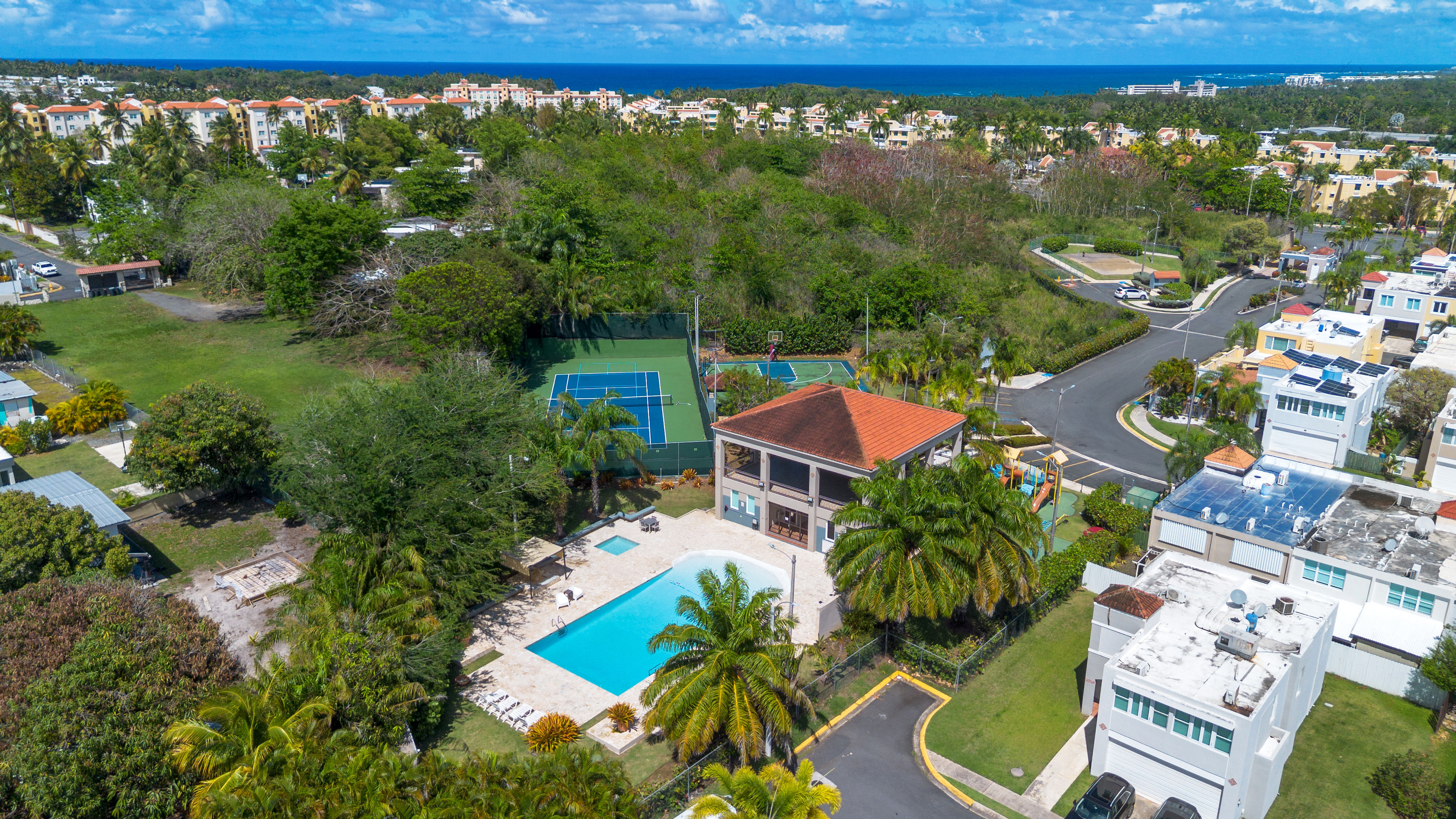 Community amenities including pool, clubhouse, tennis court, and green areas within Cielo Dorado Village