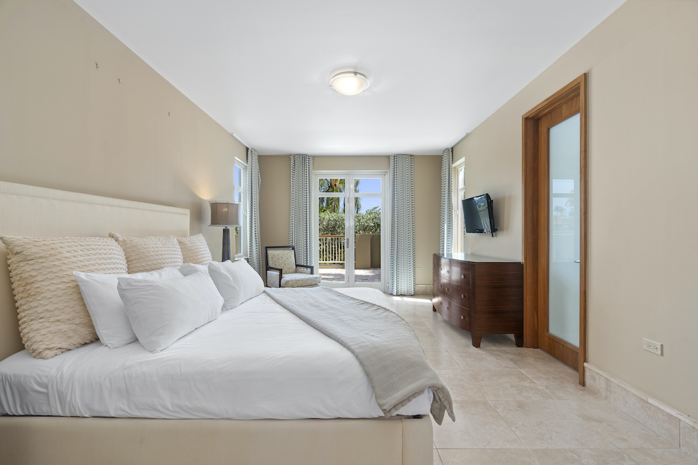 Plantation Village 2-108 guest bedroom with balcony access and natural light