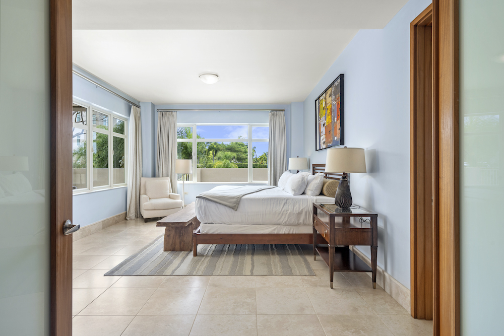 Plantation Village 2-108 primary bedroom with large windows and natural light