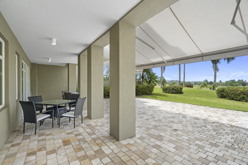 Plantation Village 2-108 covered terrace with outdoor seating and golf course views