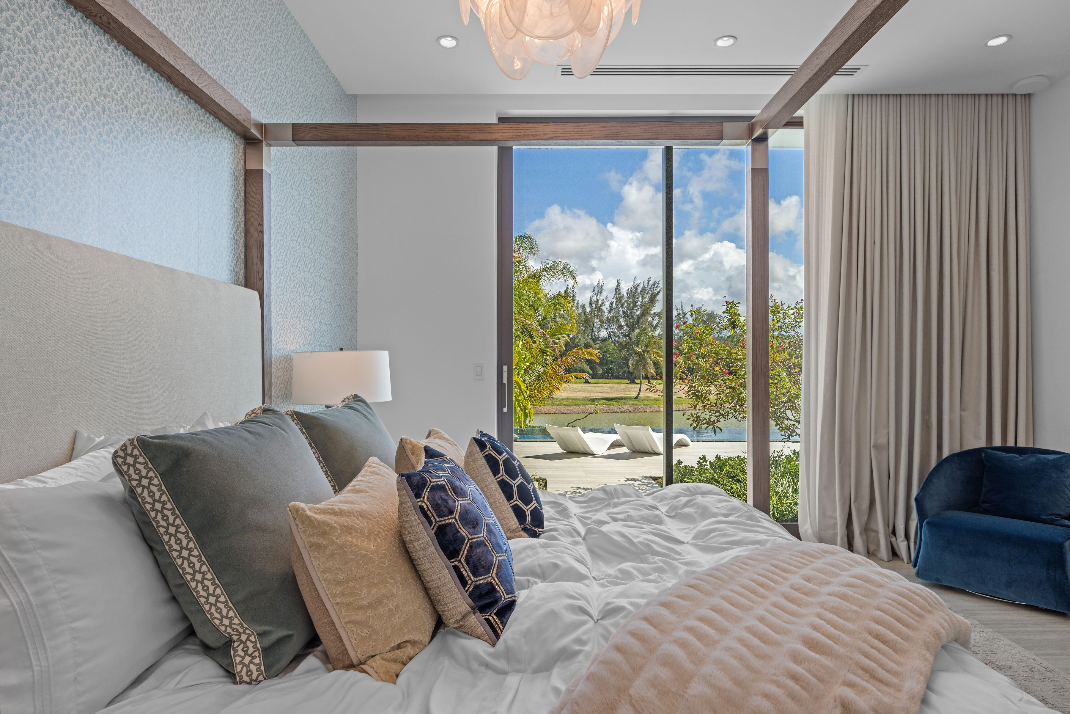 Dorado Beach Resort The Isles residence primary bedroom detail with sliding glass doors and outdoor views
