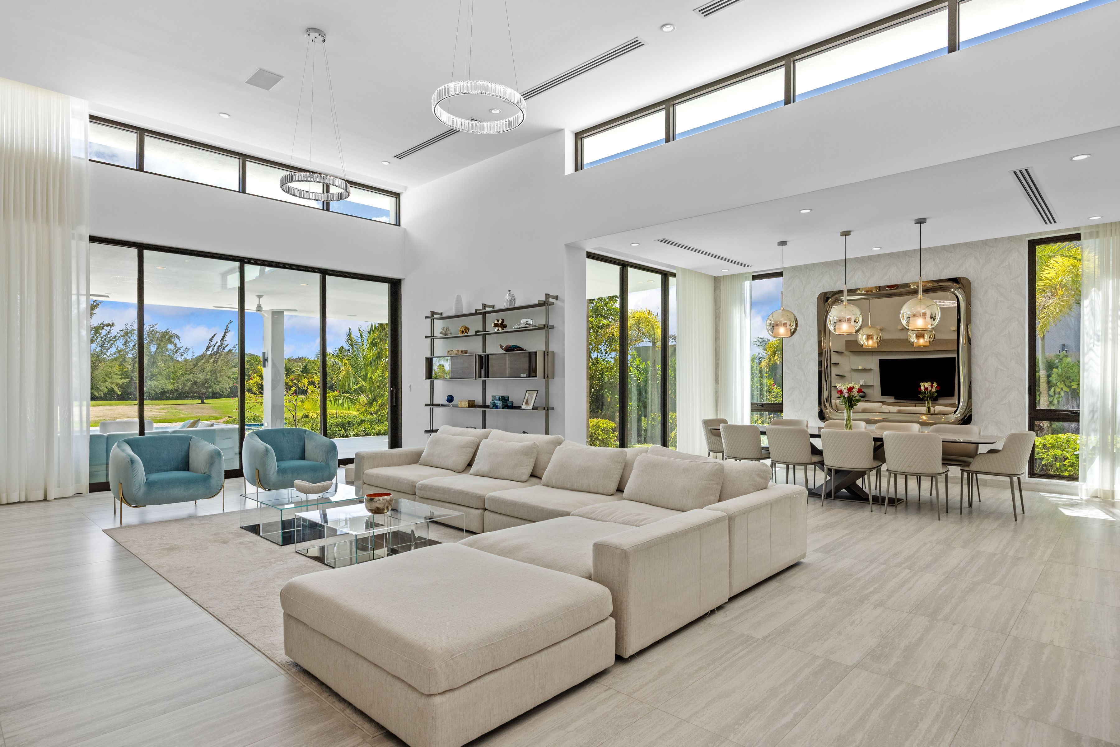 Dorado Beach Resort The Isles residence spacious living room with floor-to-ceiling glass doors connecting to outdoor terrace