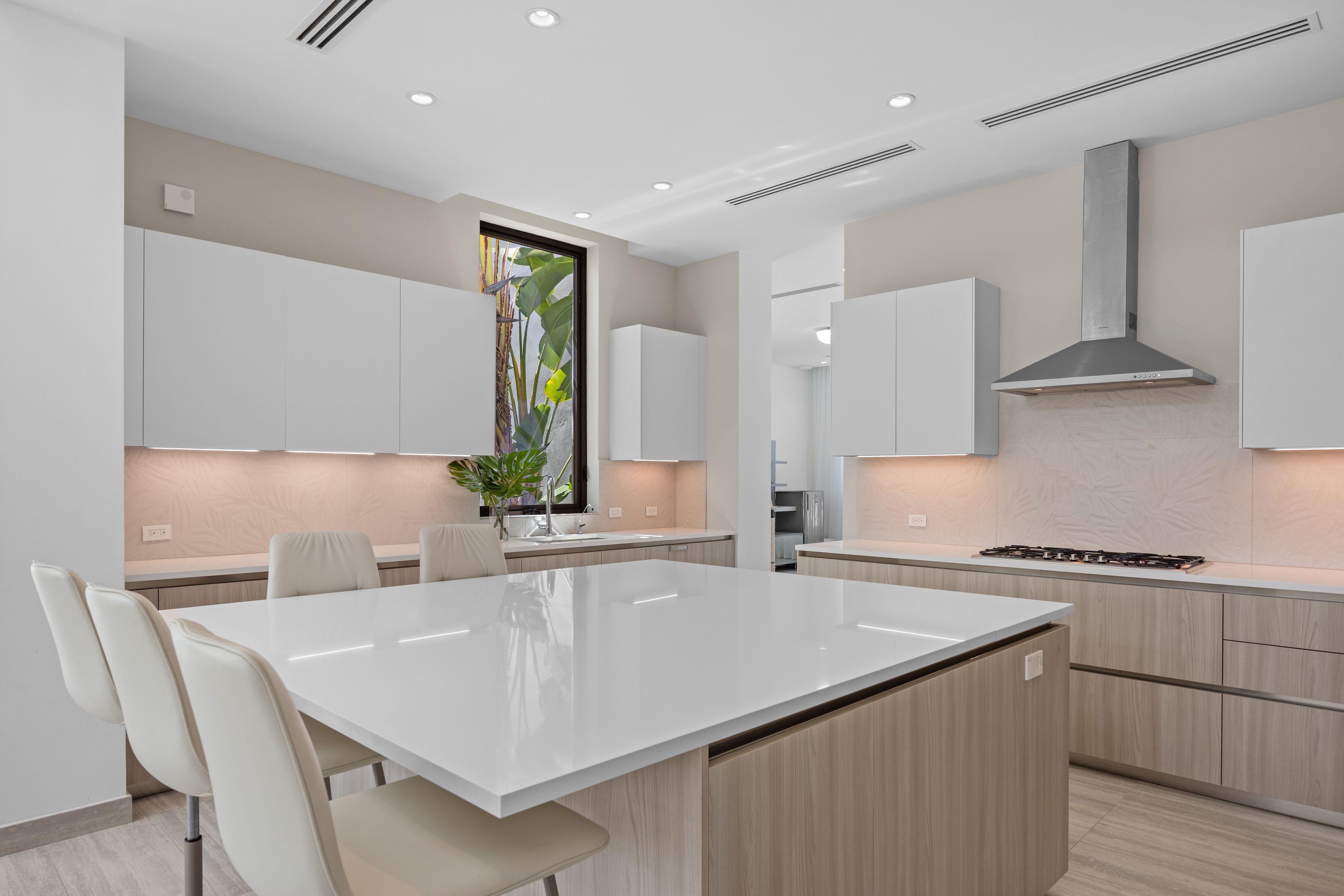 Dorado Beach Resort The Isles residence contemporary kitchen with large island, custom cabinetry, and integrated appliances