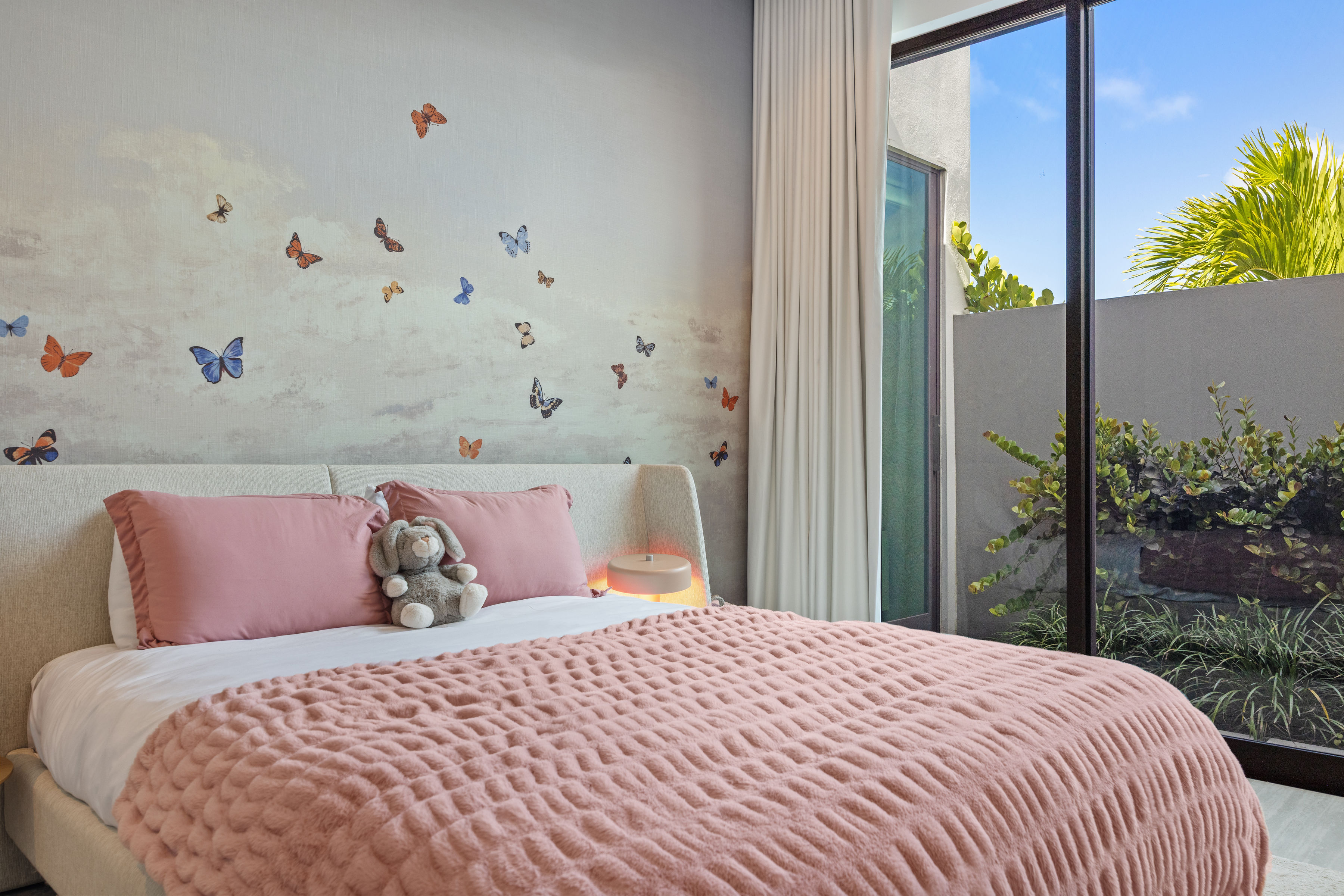 Dorado Beach Resort The Isles residence bedroom with butterfly wall design and garden-facing window