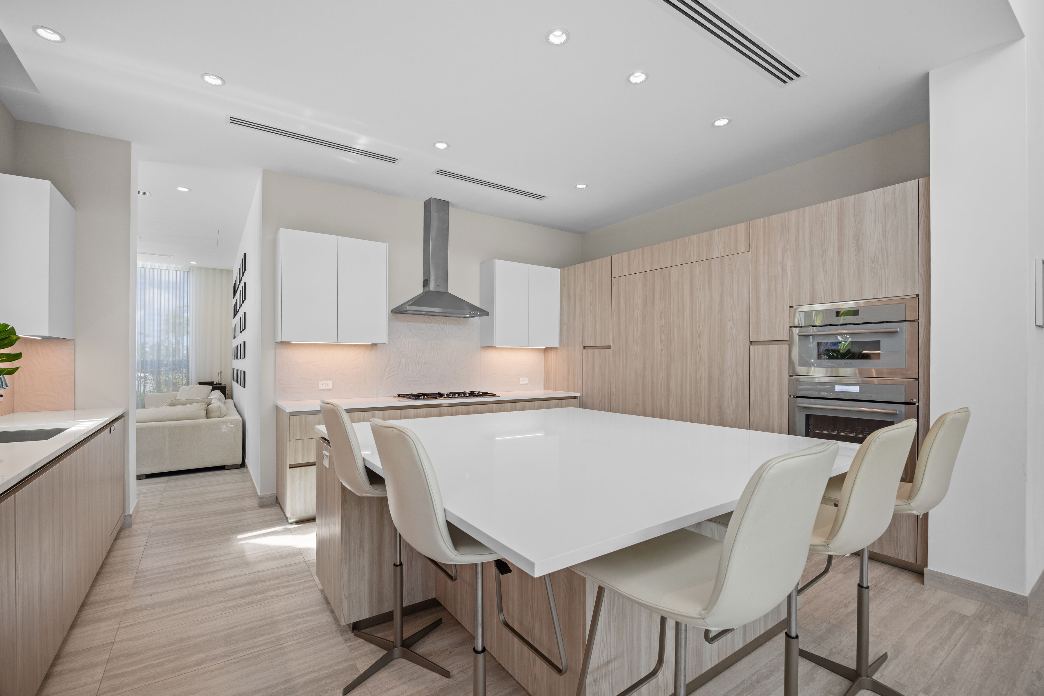 Dorado Beach Resort The Isles residence contemporary kitchen with large island, custom cabinetry, and integrated appliances