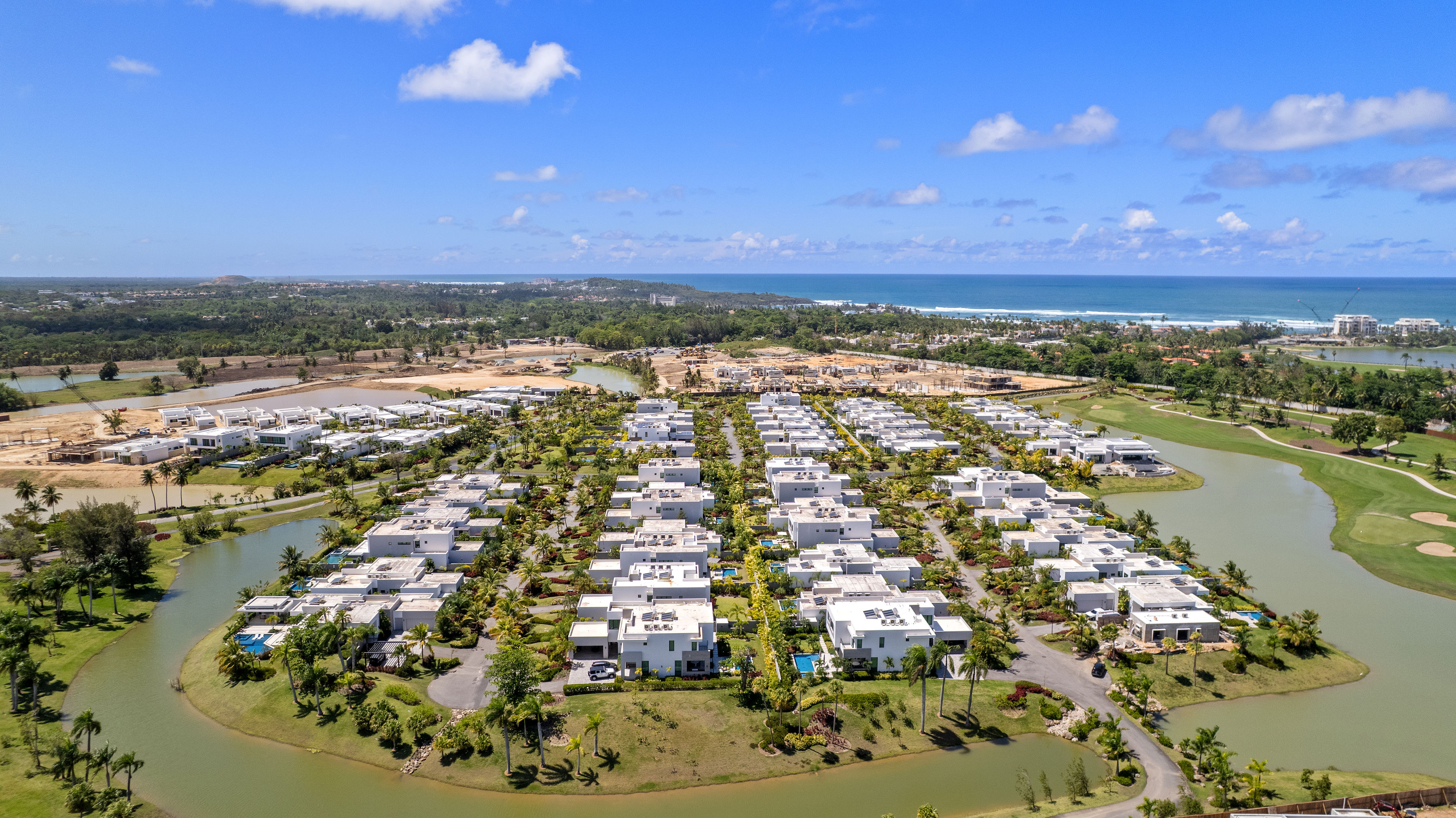 Dorado Beach Resort The Isles community aerial view with golf course, lakes, and ocean in background