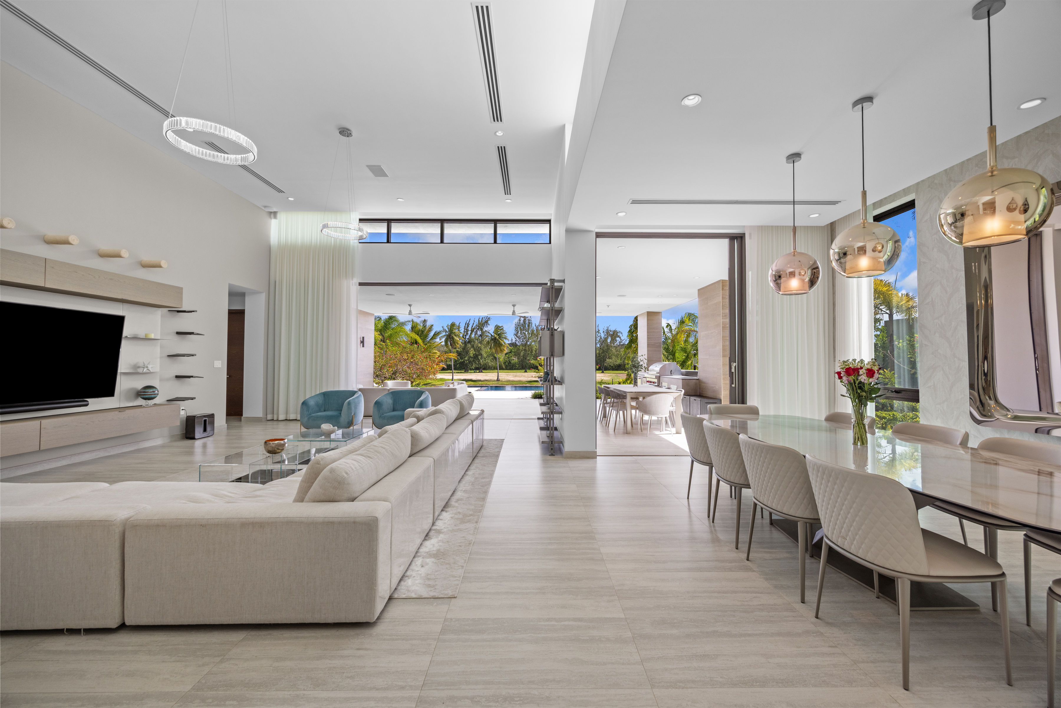 Dorado Beach Resort The Isles residence open-concept living and dining area with double-height ceilings and golf course views