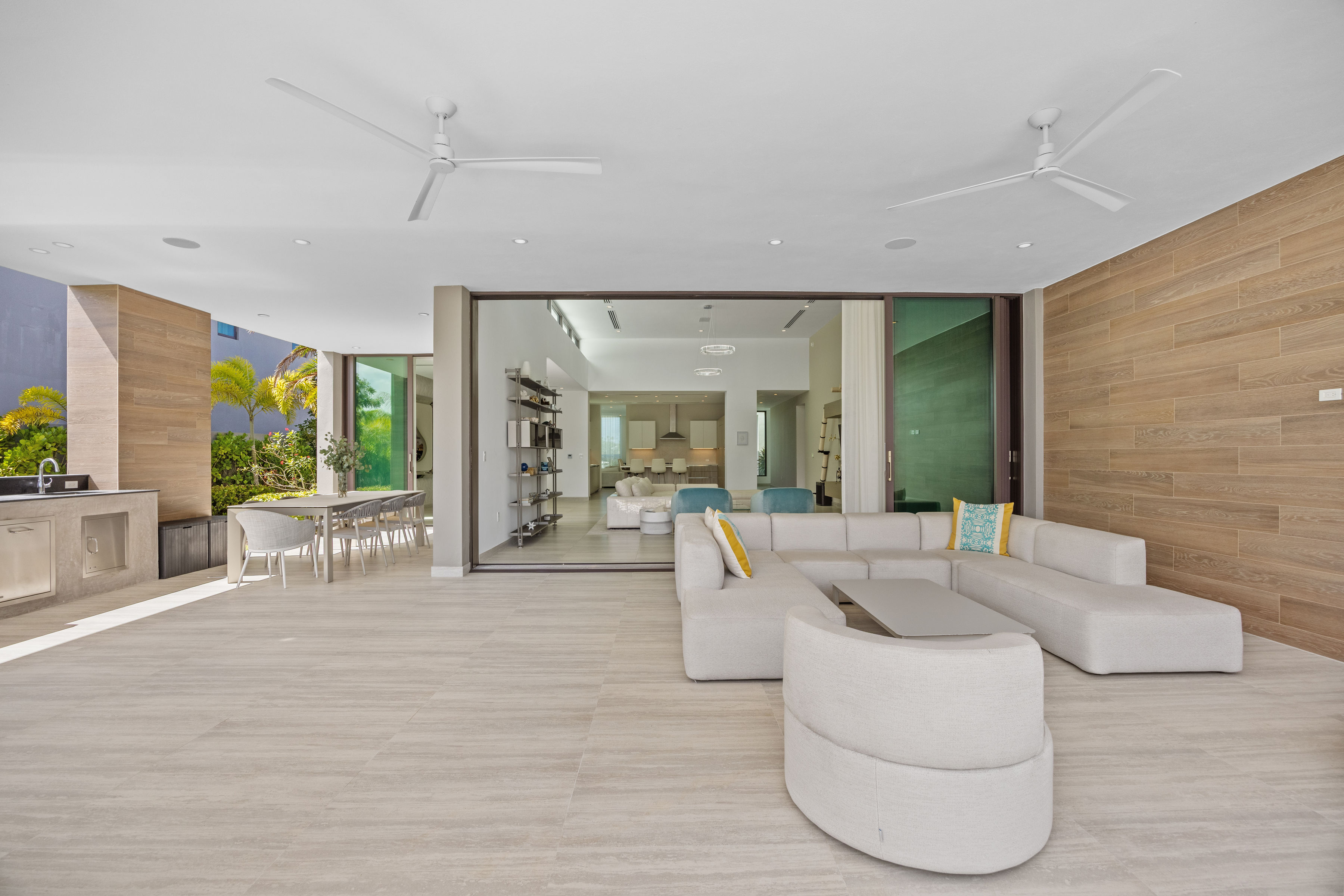 Dorado Beach Resort The Isles residence outdoor lounge with seamless indoor-outdoor flow and sliding glass walls