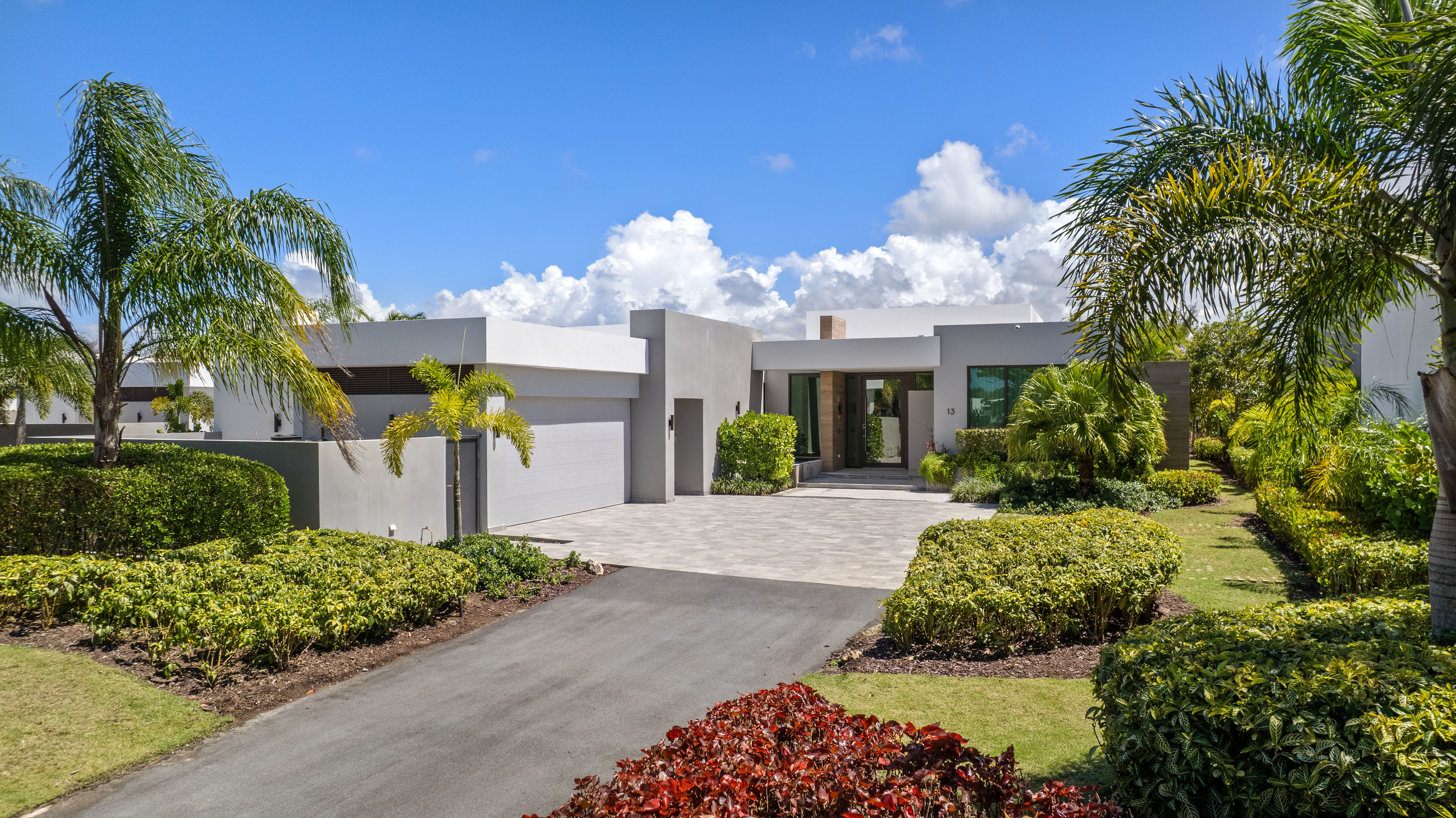 Dorado Beach Resort The Isles residence front exterior with driveway, garage, and landscaped entrance