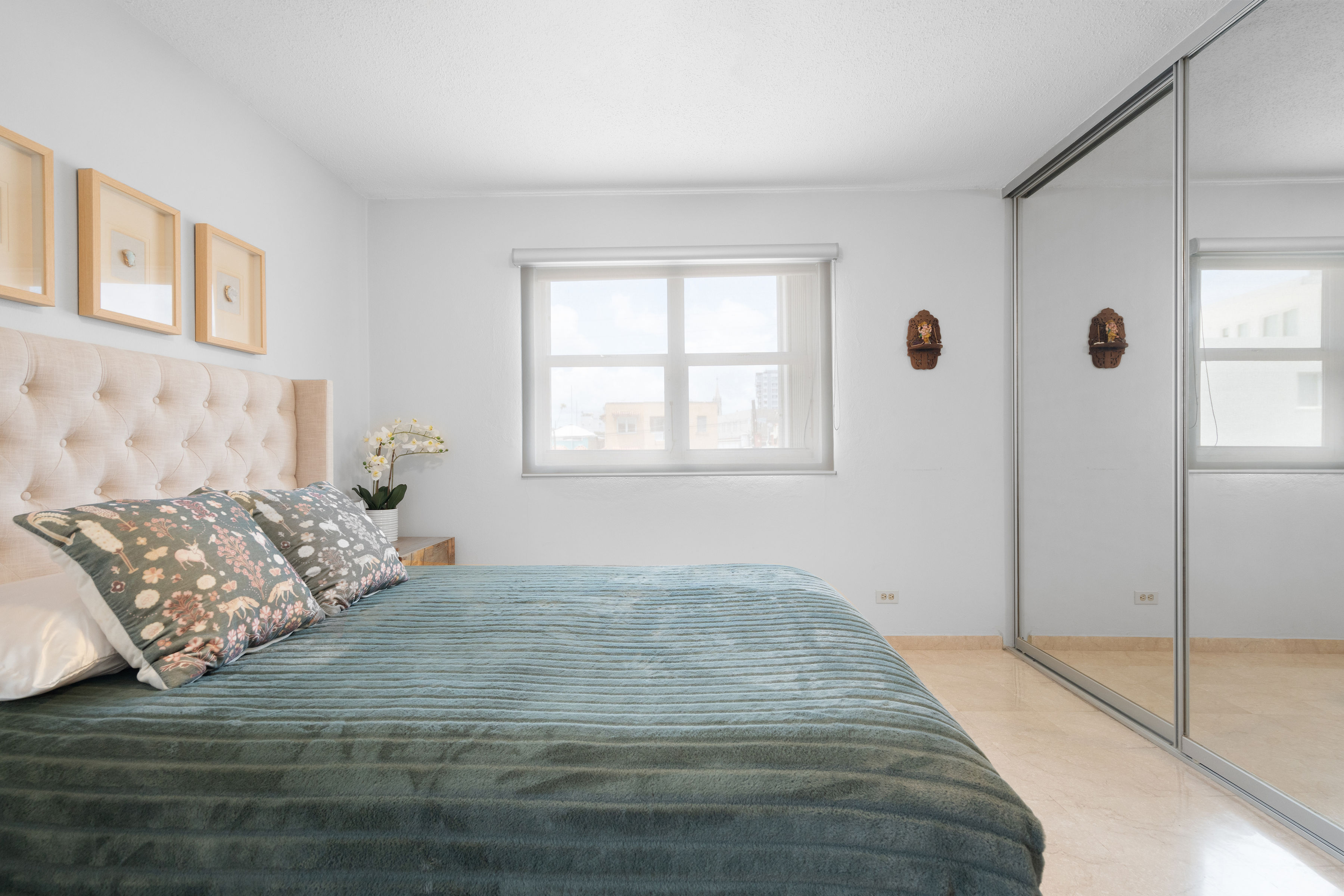 Kings Court 81 Condado | Primary bedroom with mirrored closet doors and ample storage space