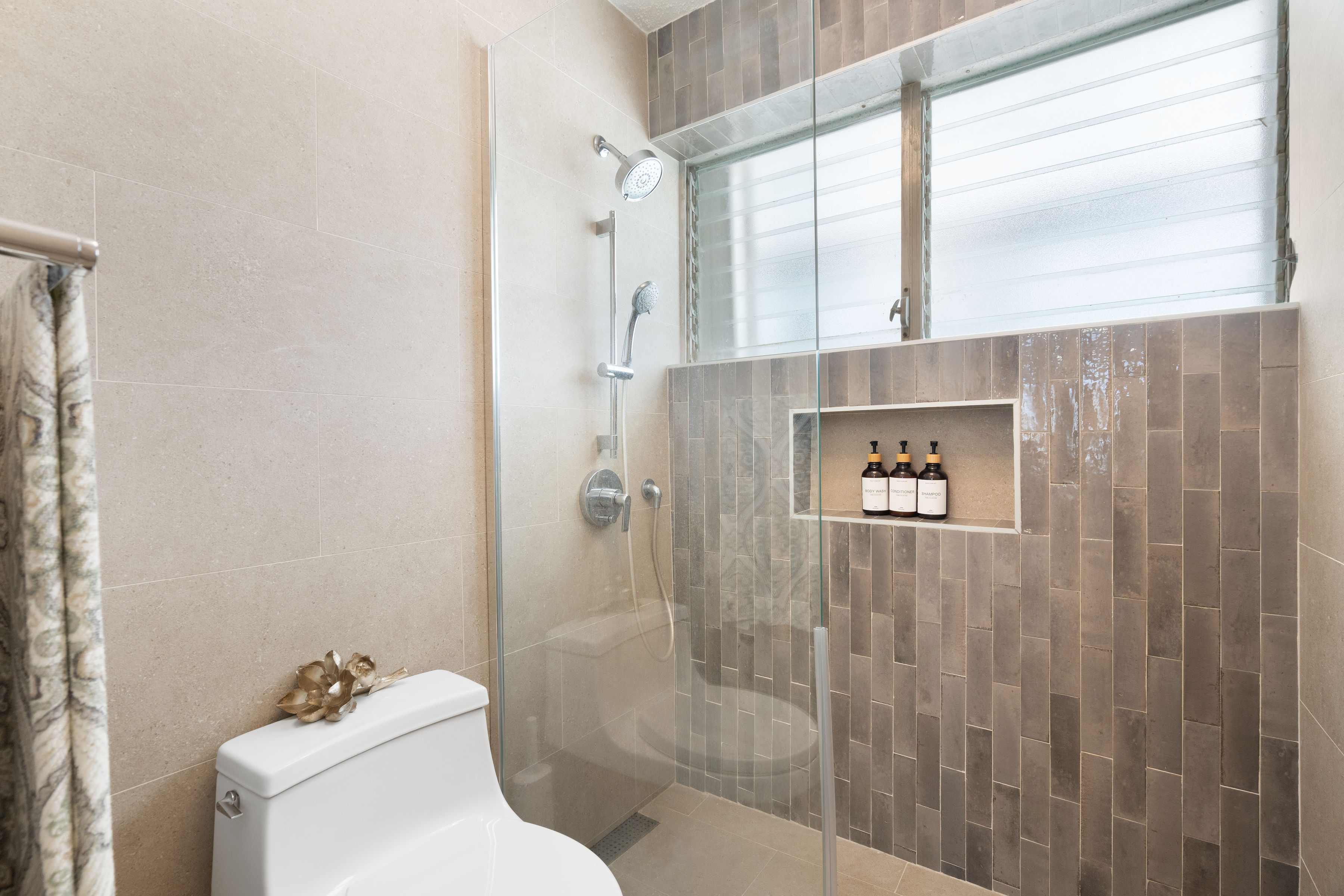 Kings Court 81 Condado | Modern bathroom featuring a glass-enclosed shower and built-in storage niche