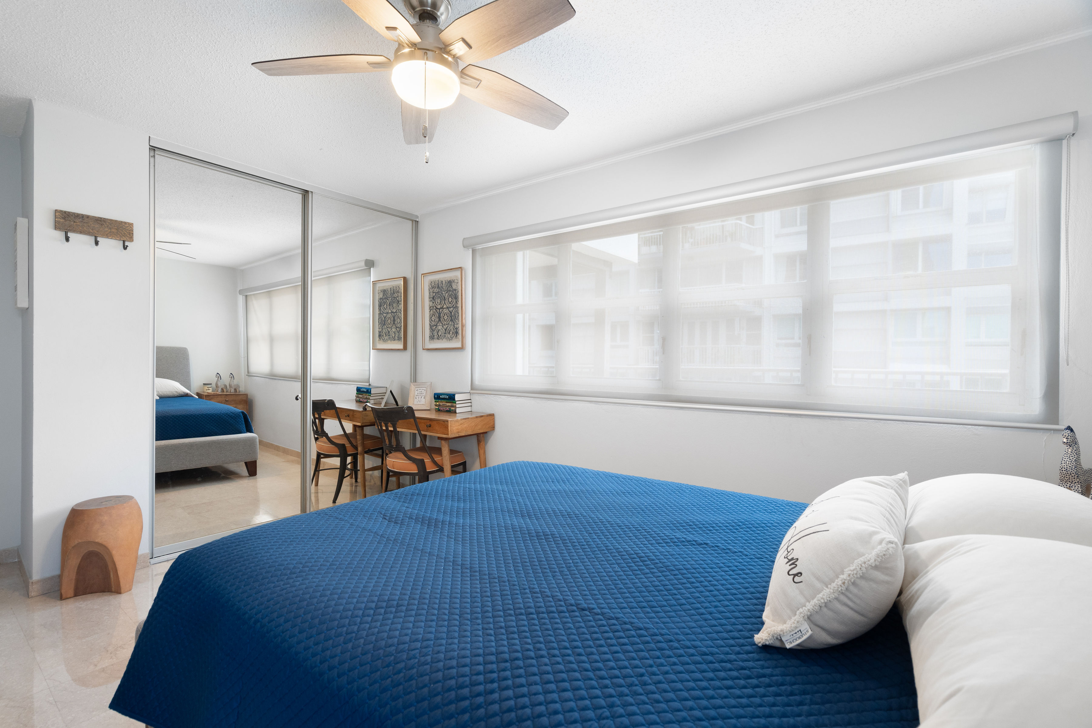Kings Court 81 Condado | Secondary bedroom featuring mirrored closets and dedicated desk space