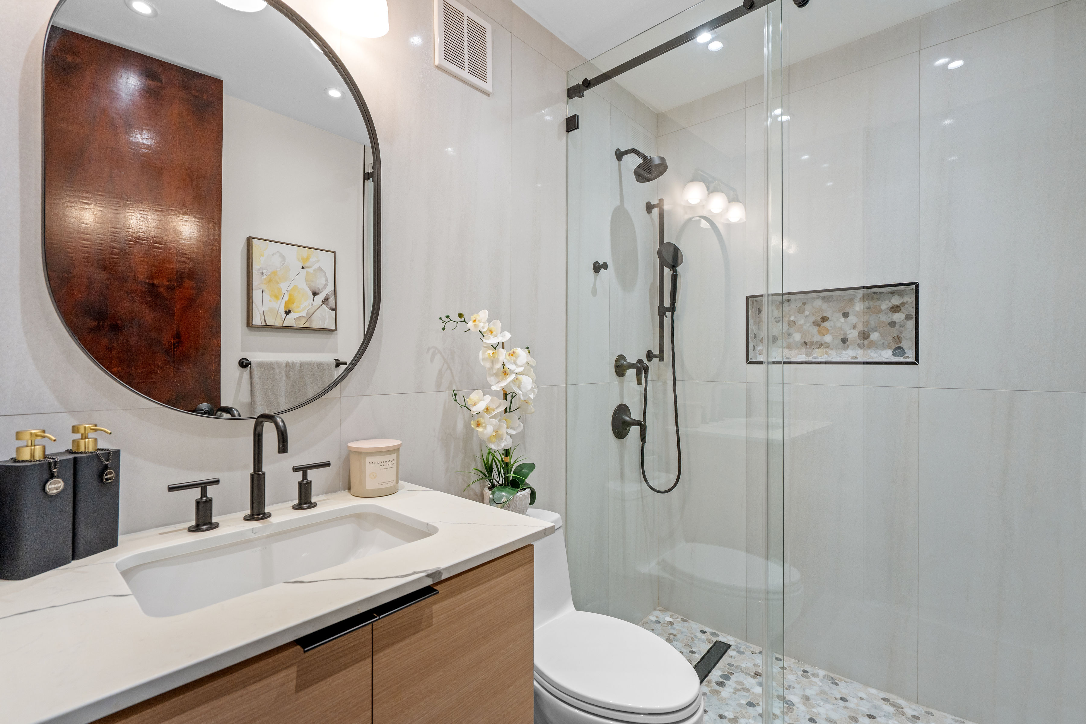 Royal Palm Vega Alta | Renovated secondary bathroom with quartz vanity and glass-enclosed walk-in shower