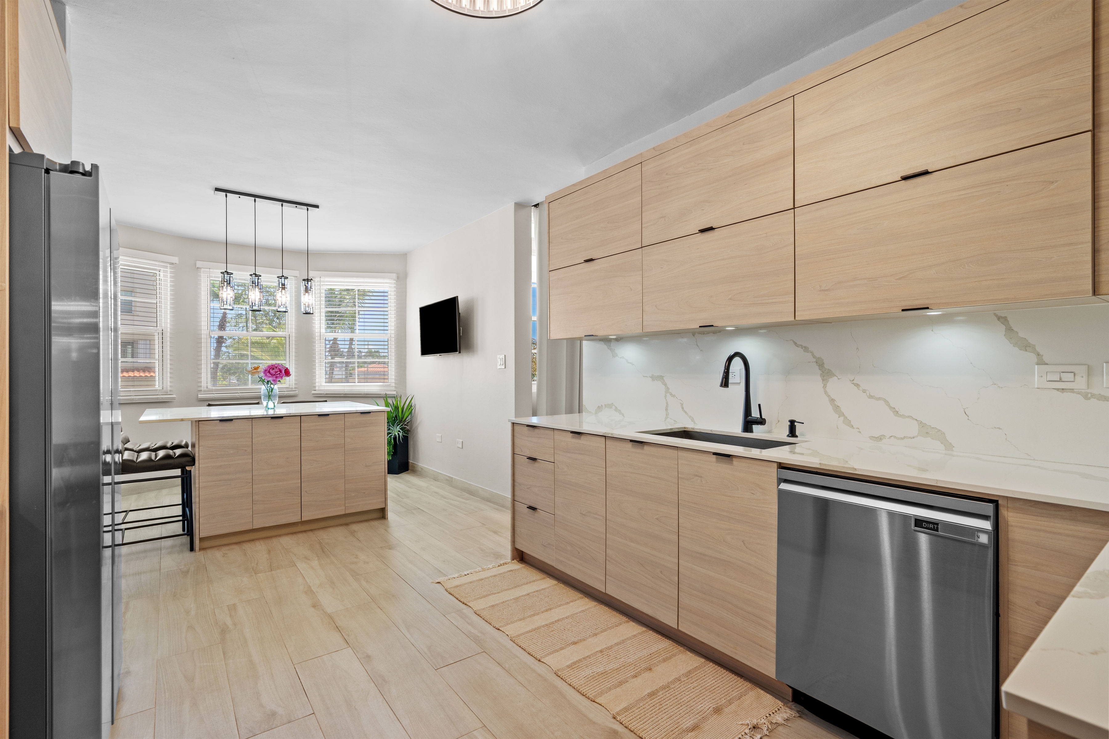 Royal Palm Vega Alta | Kitchen with center island, dining nook, and natural light