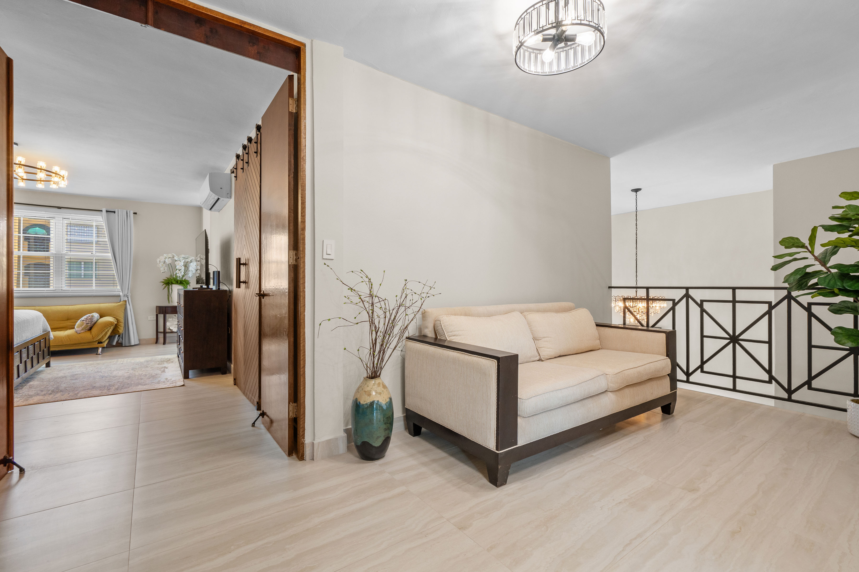 Royal Palm Vega Alta | Second-floor sitting area overlooking the double-height living space