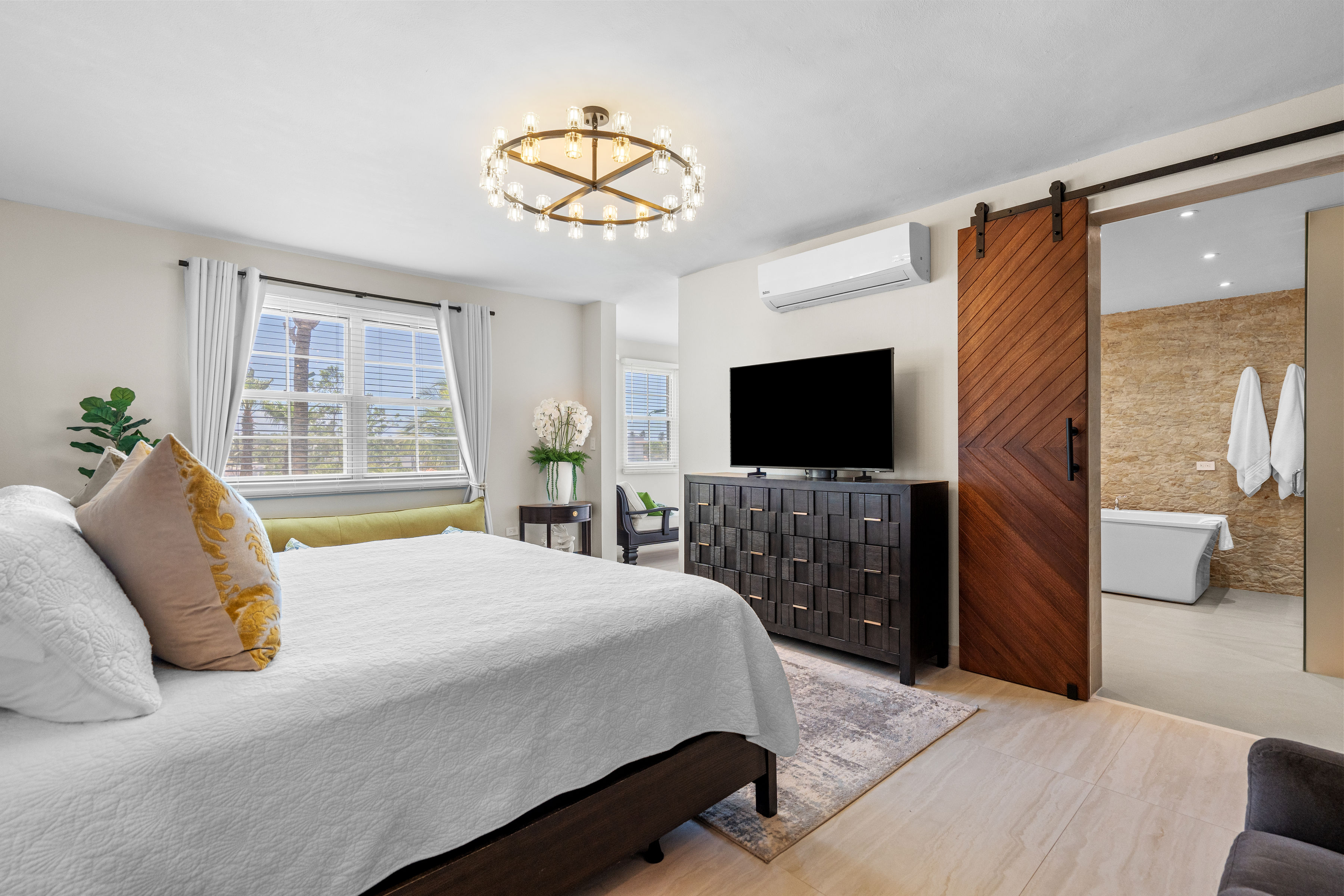 Royal Palm Vega Alta | Spacious primary bedroom with sitting area and oversized windows