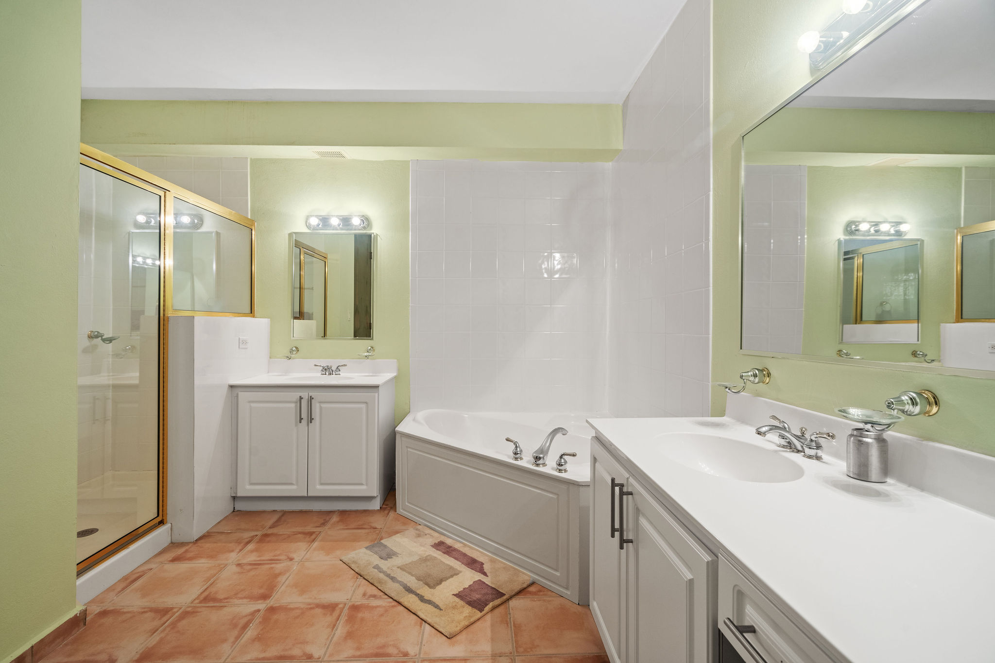 Royal Palm primary bathroom with dual vanities, shower, and bathtub