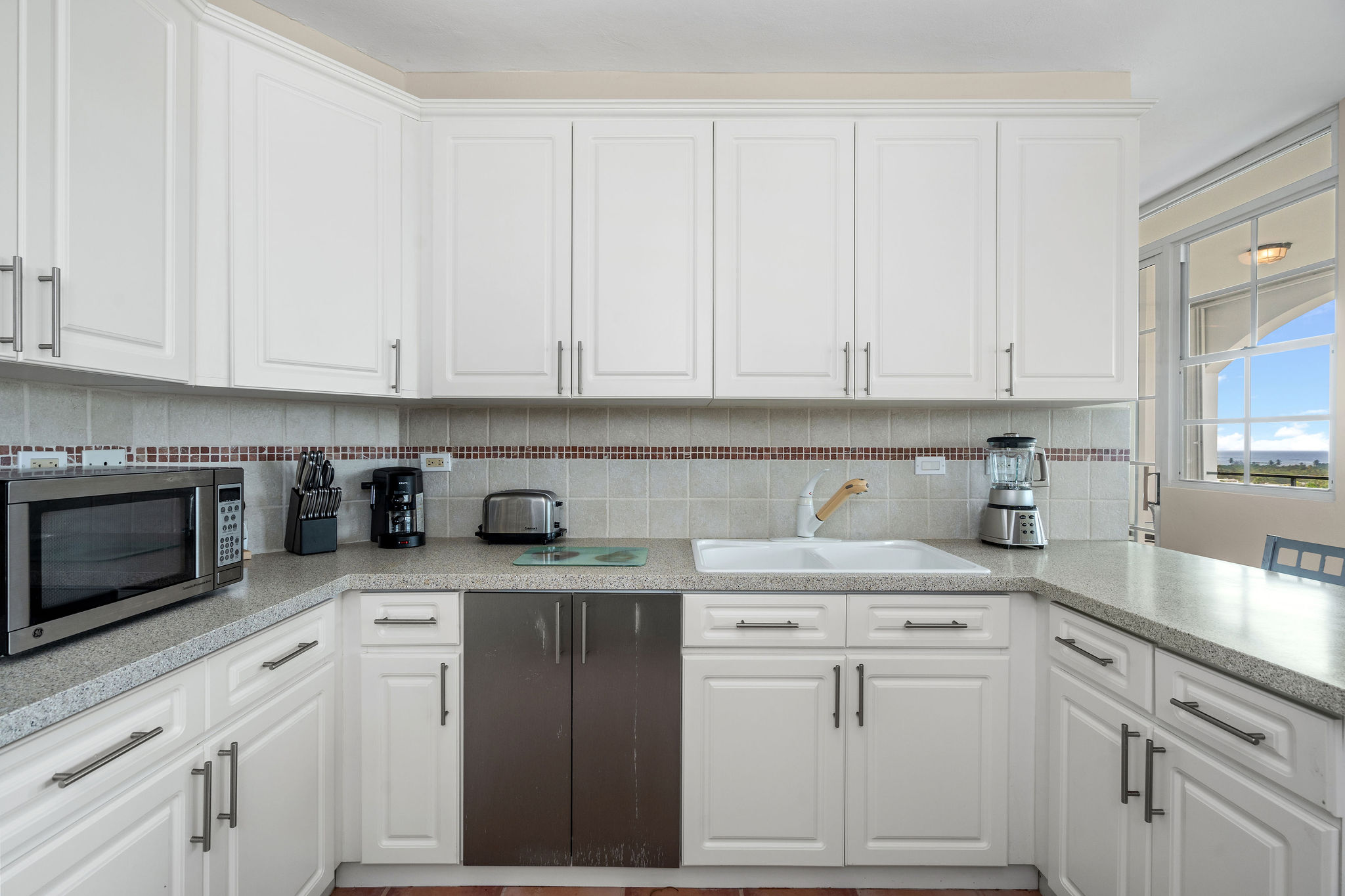 Royal Palm kitchen with white cabinetry and generous counter space