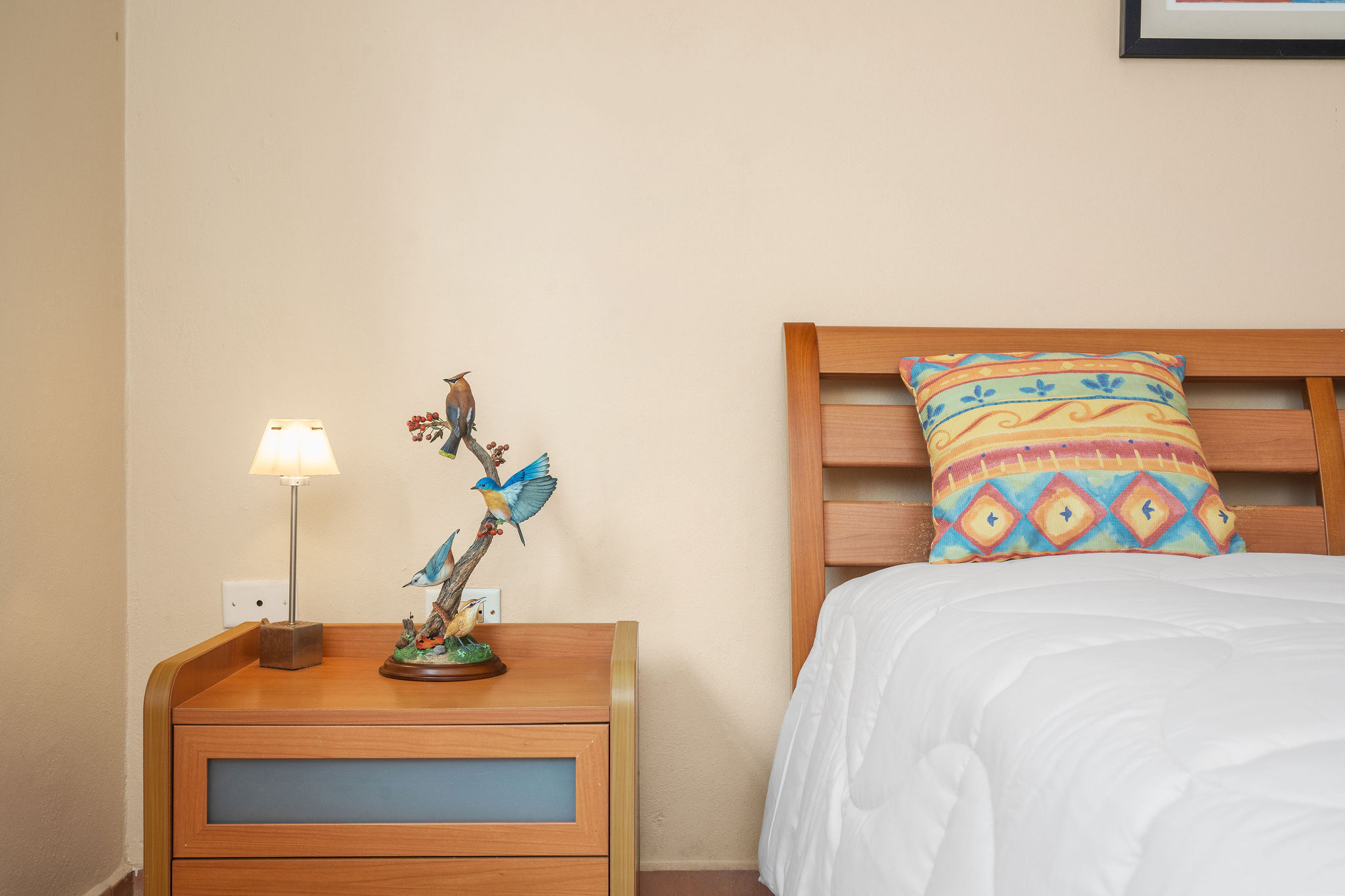 Royal Palm primary bedroom with warm tropical decor