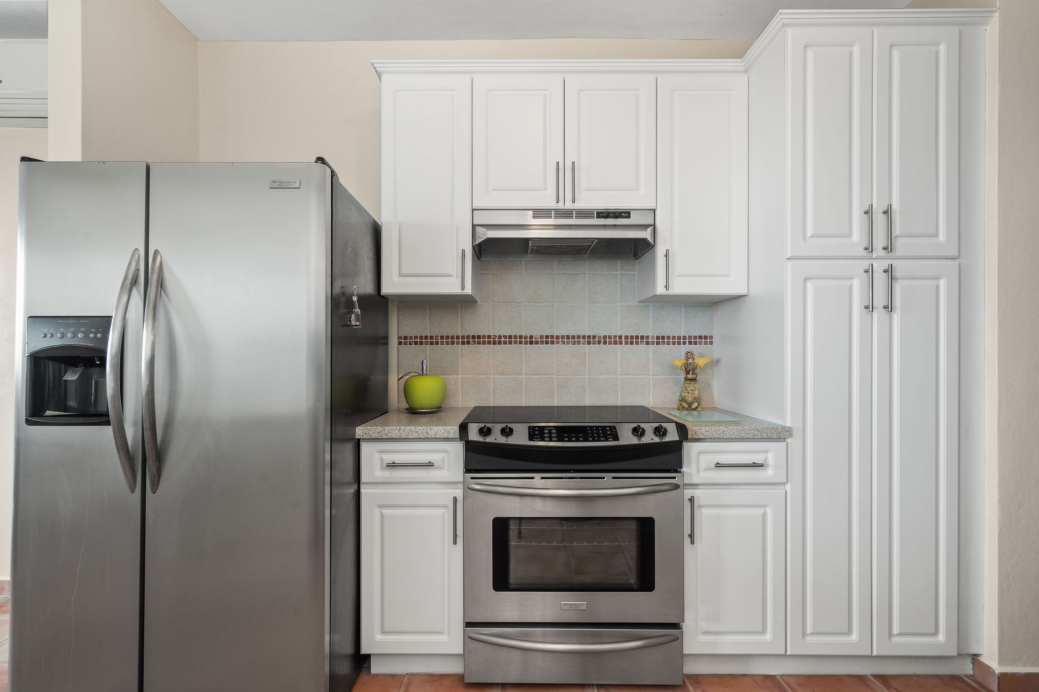 Royal Palm kitchen with stainless steel range and refrigerator