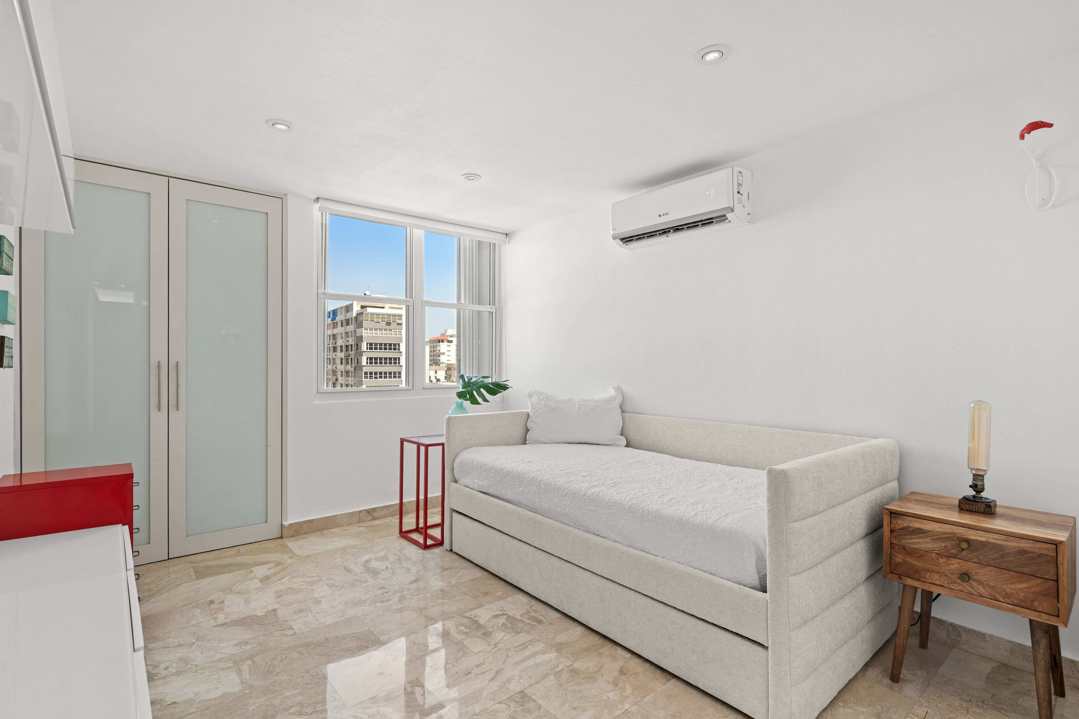 Las Olas Condado furnished secondary bedroom with natural light
