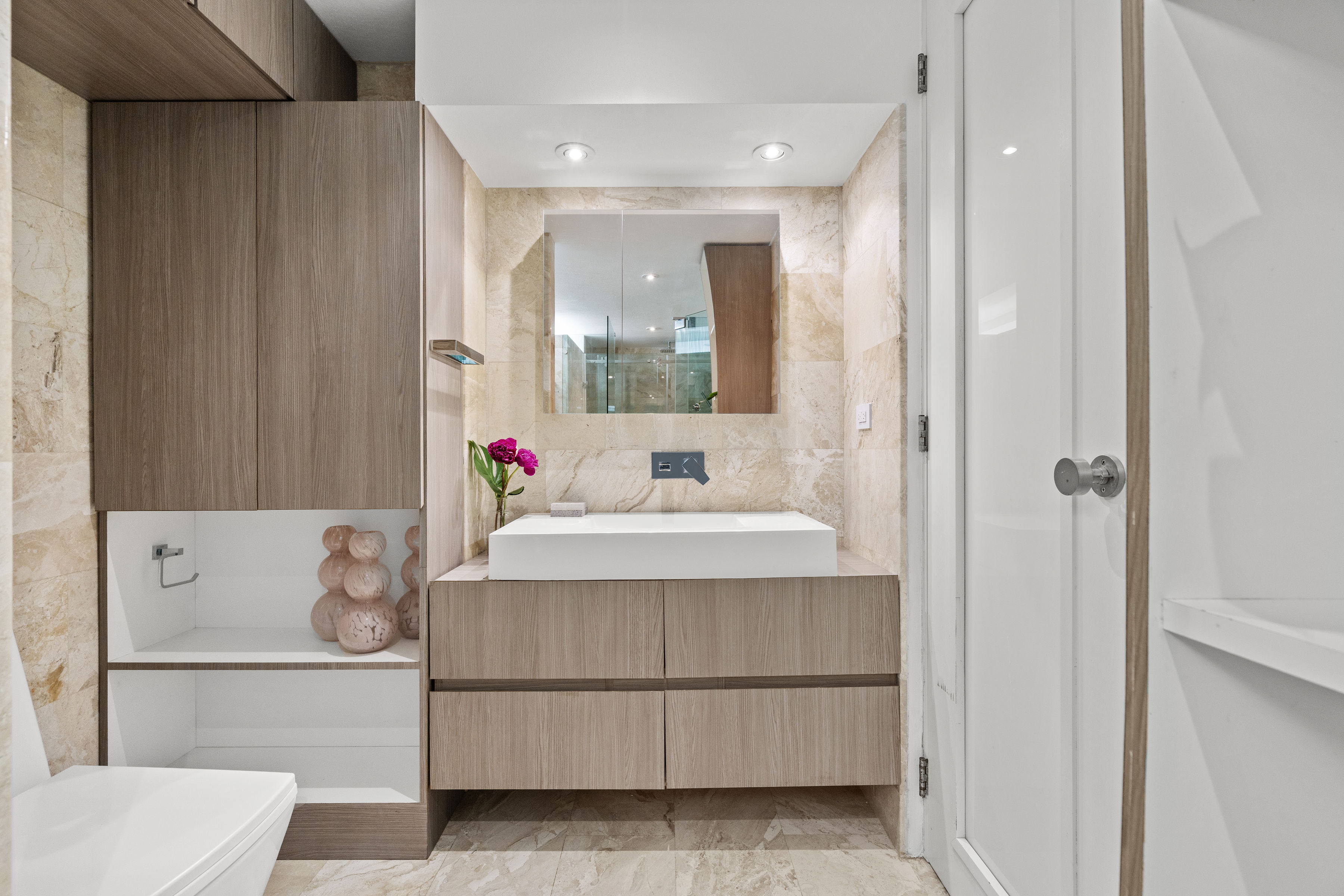 Las Olas Condado renovated primary bathroom with modern wood vanity