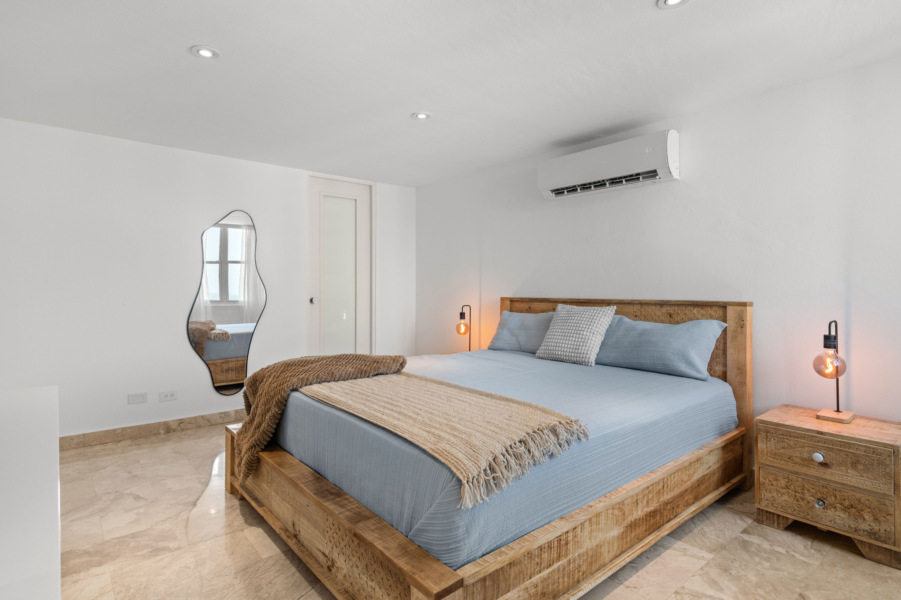 Las Olas Condado furnished primary bedroom with contemporary coastal design