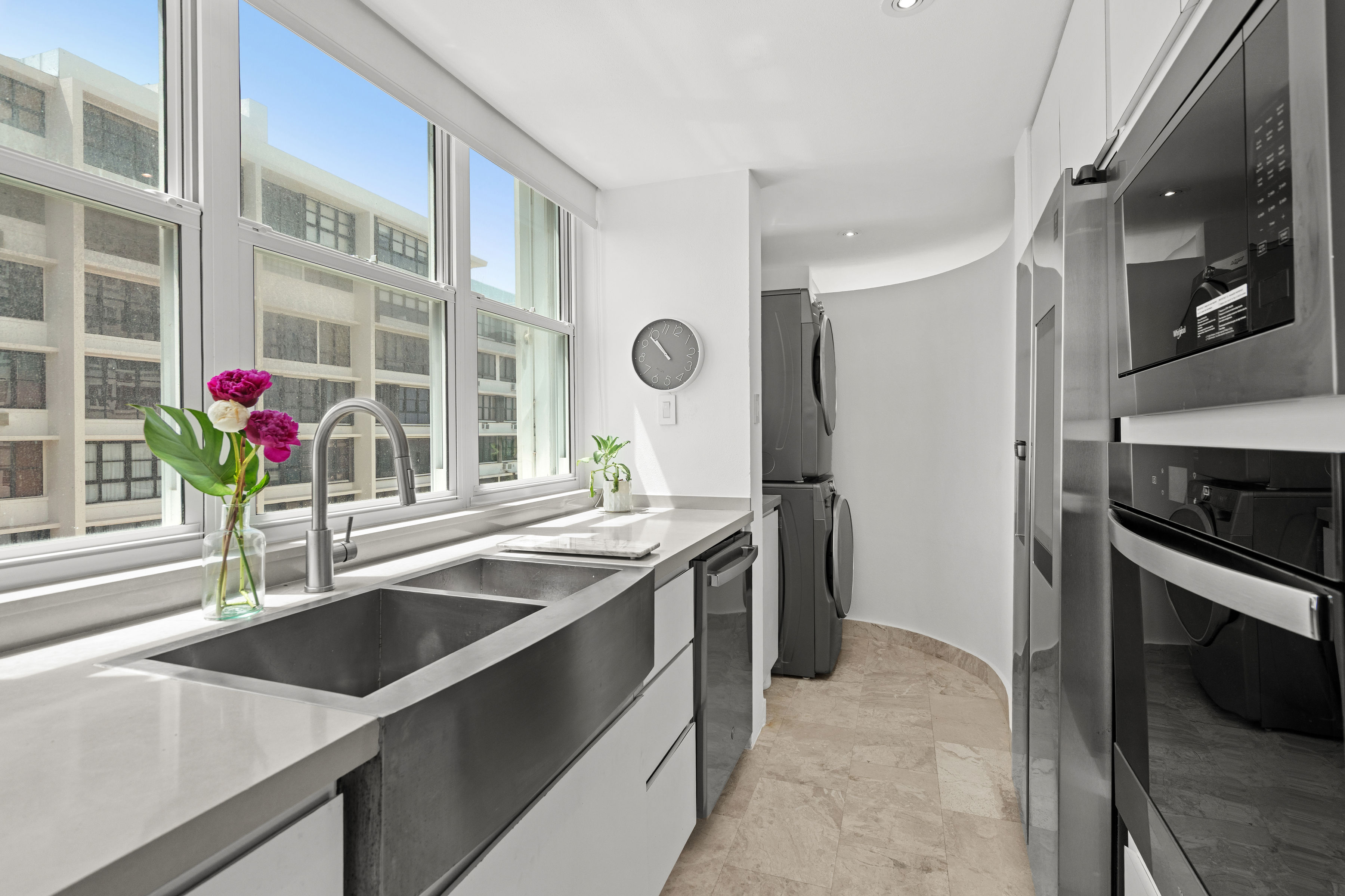 Las Olas Condado contemporary kitchen with stainless steel appliances and city views