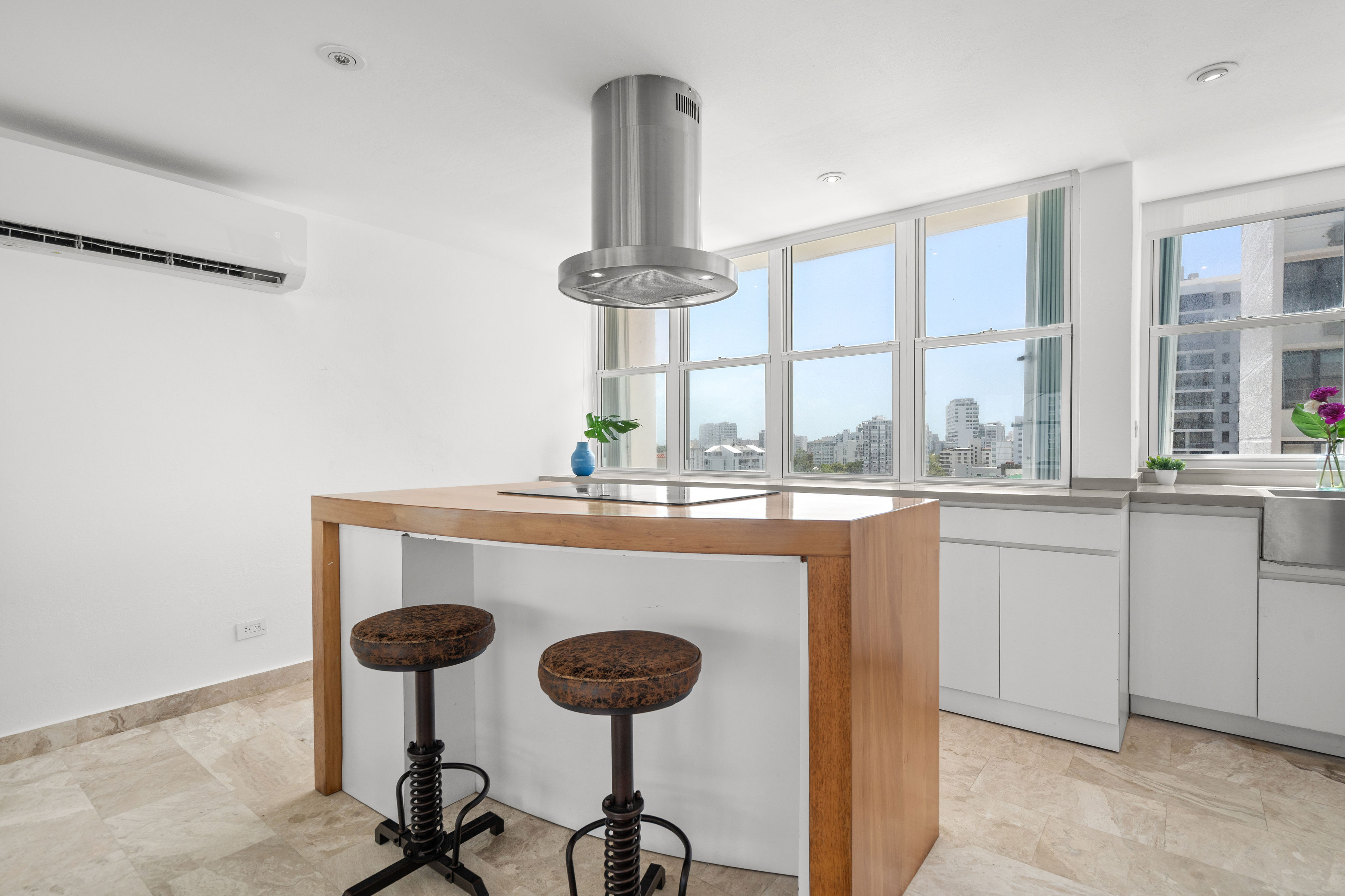Las Olas Condado renovated kitchen with wood island and breakfast seating