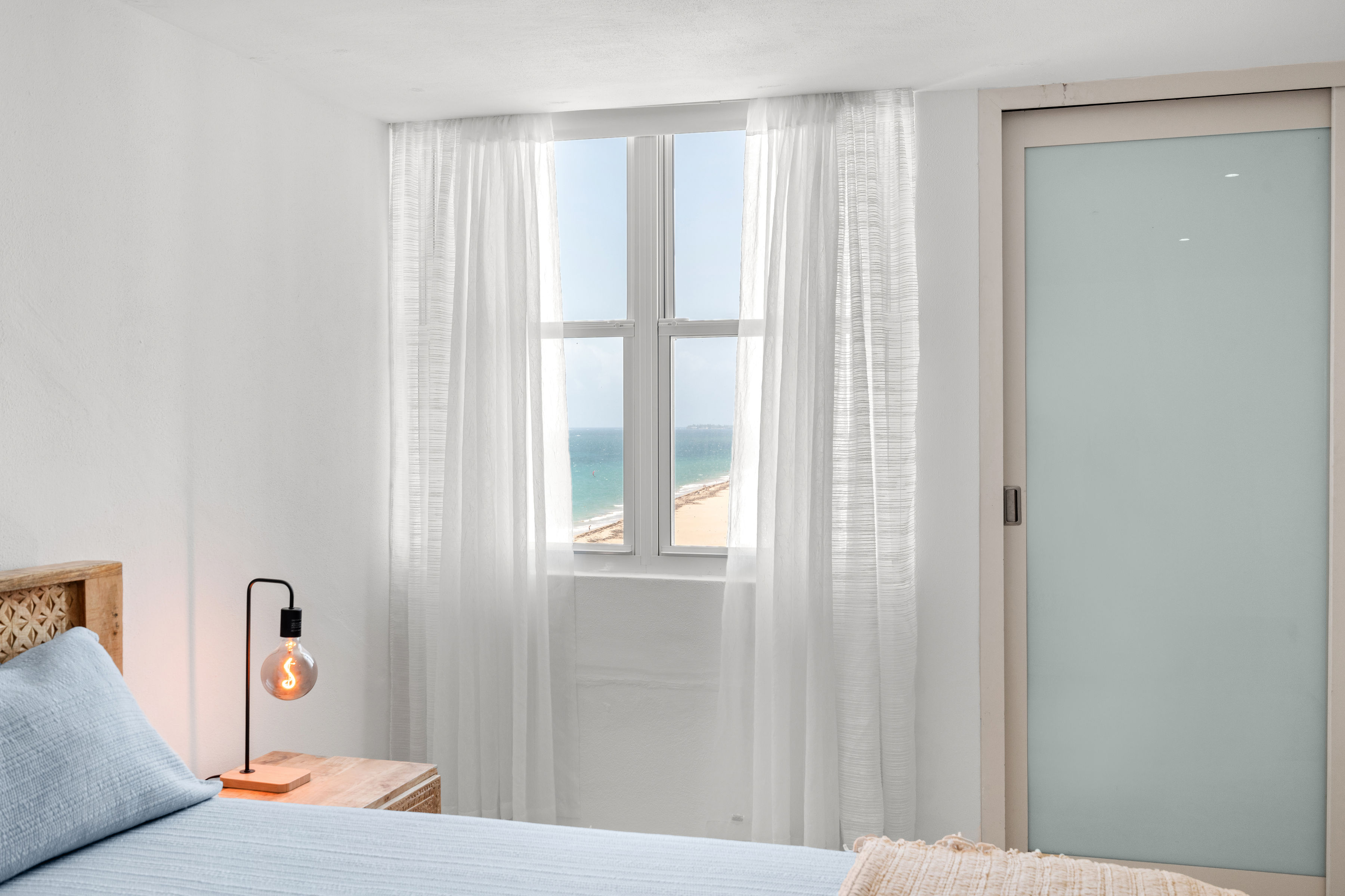 Las Olas Condado primary bedroom window with ocean view