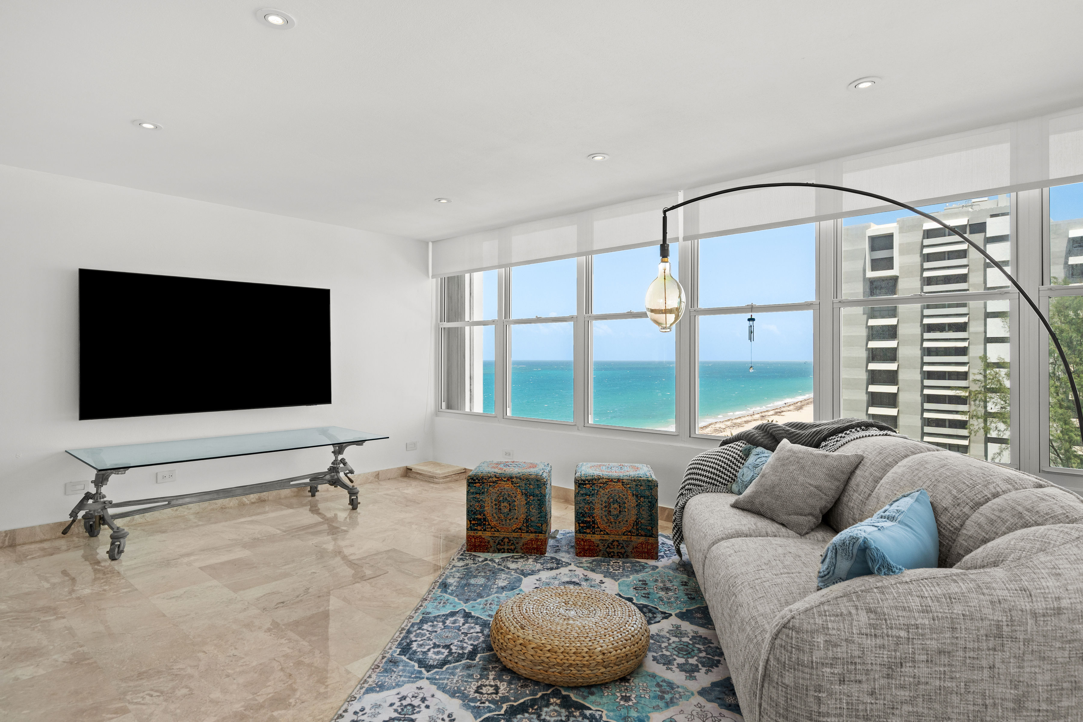 Las Olas Condado corner living room with ocean views and natural light