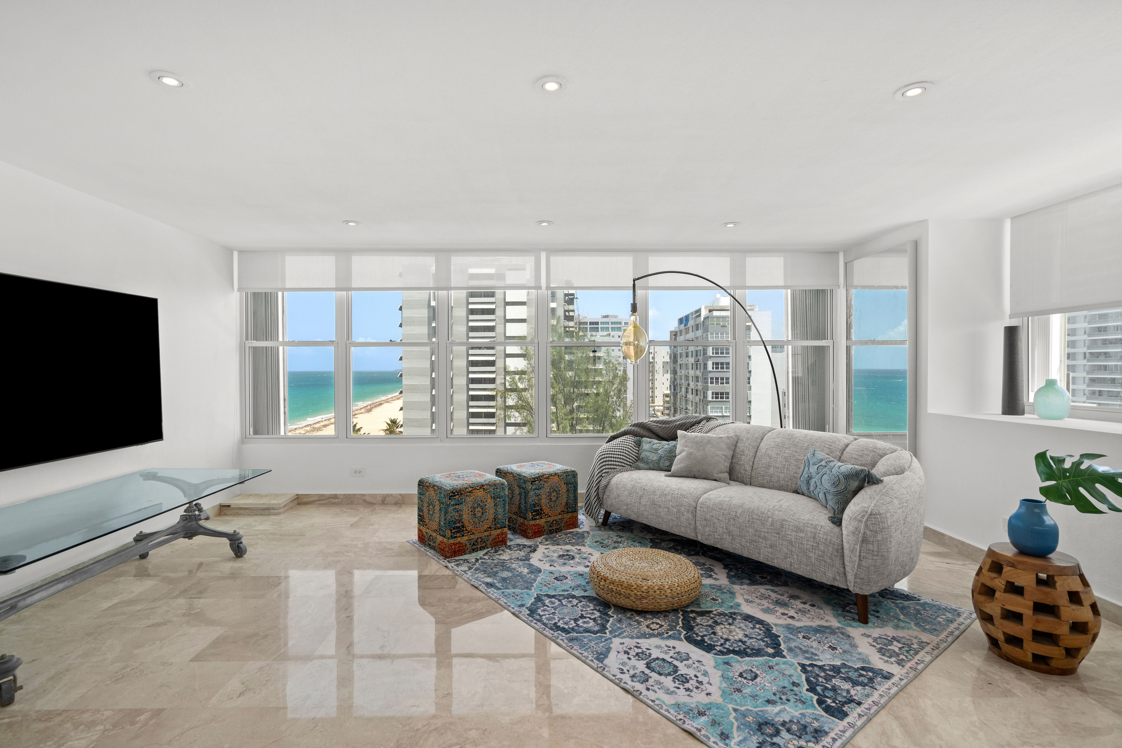 Las Olas Condado furnished living room with city and ocean views