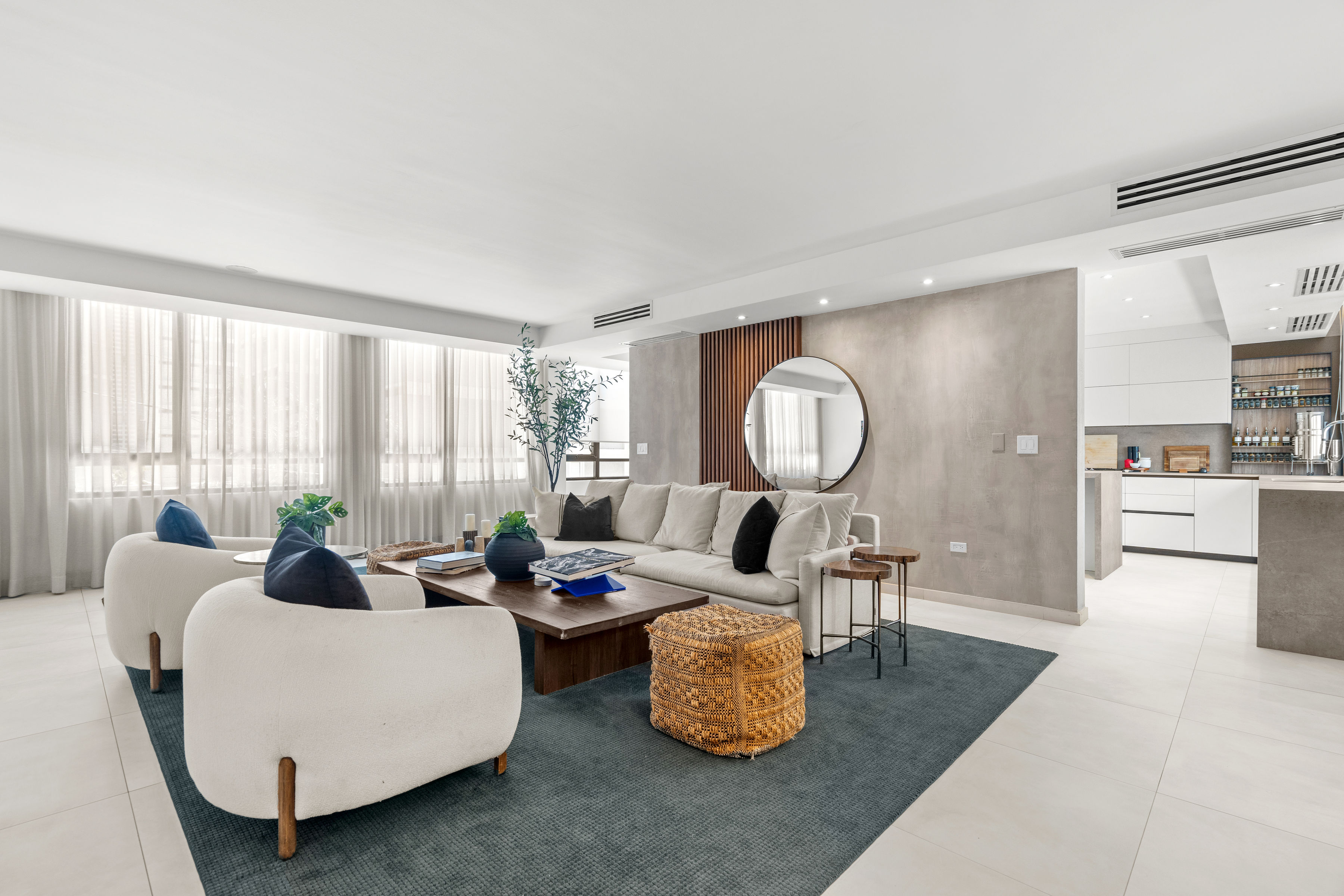 Casa Cervantes 2 | Open living area with custom feature wall, natural light, and integrated kitchen