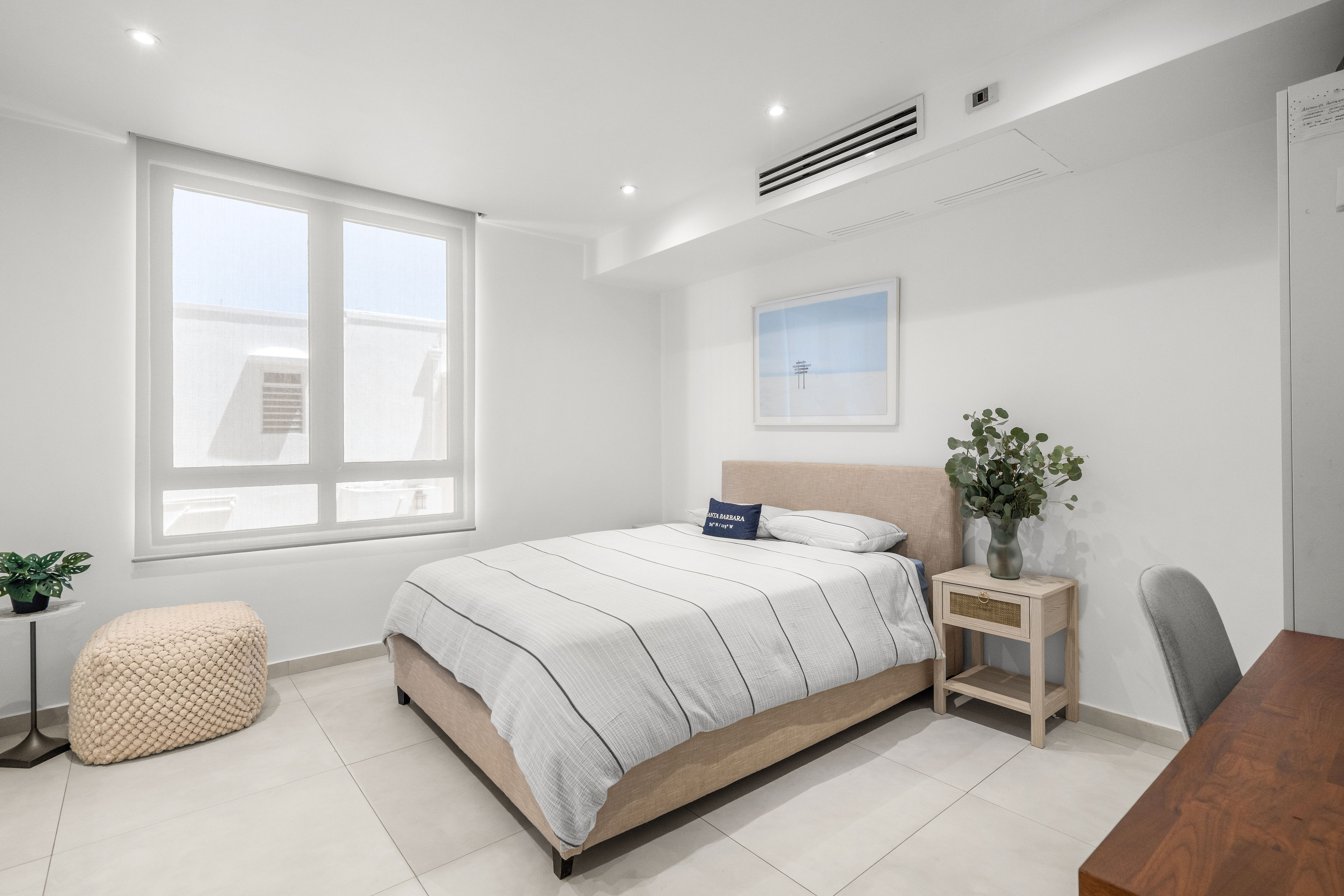 Casa Cervantes 2 | Bright secondary bedroom with large window, neutral finishes, and workspace