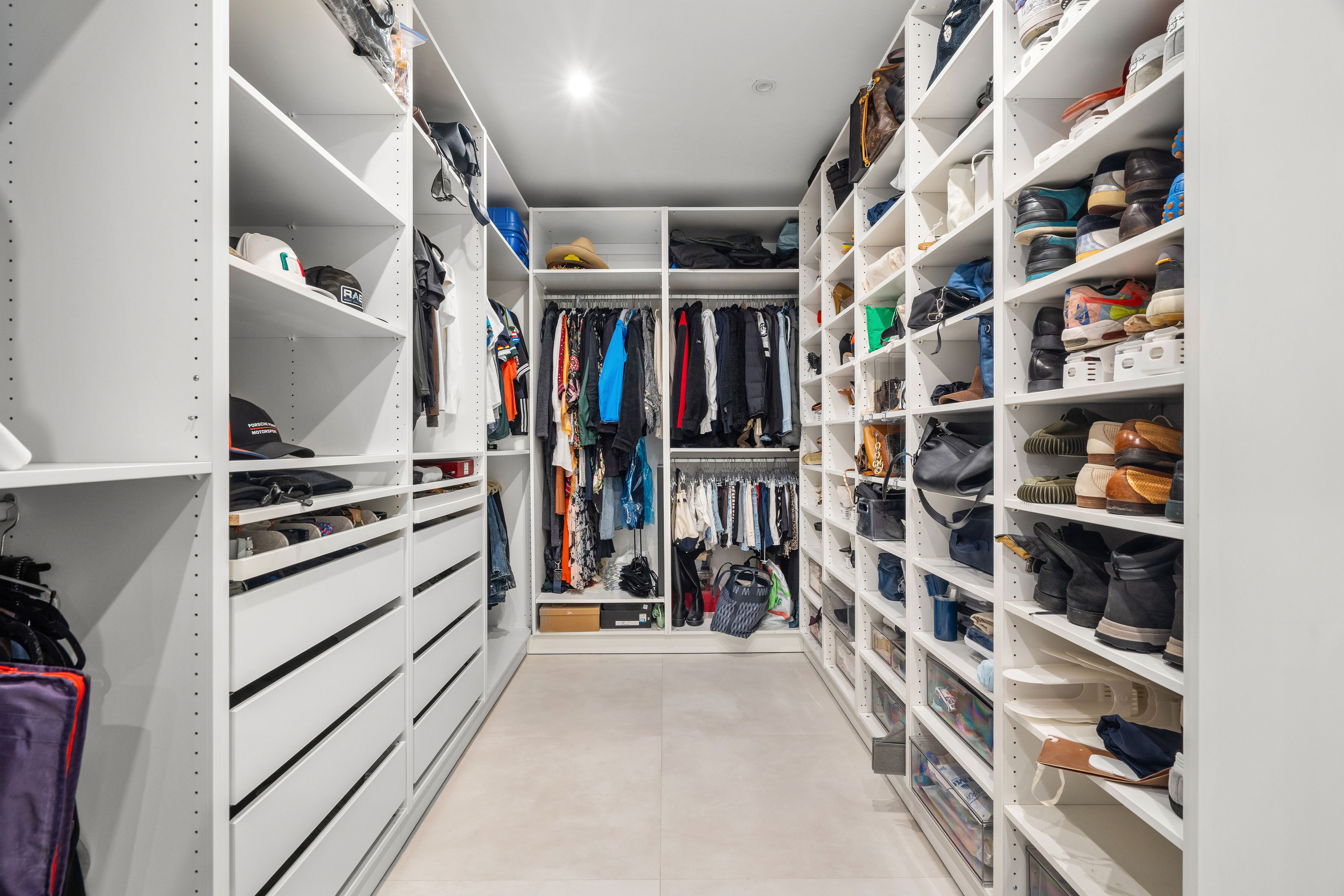 Casa Cervantes 2 | Spacious walk-in closet with custom shelving, drawers, and dedicated shoe storage