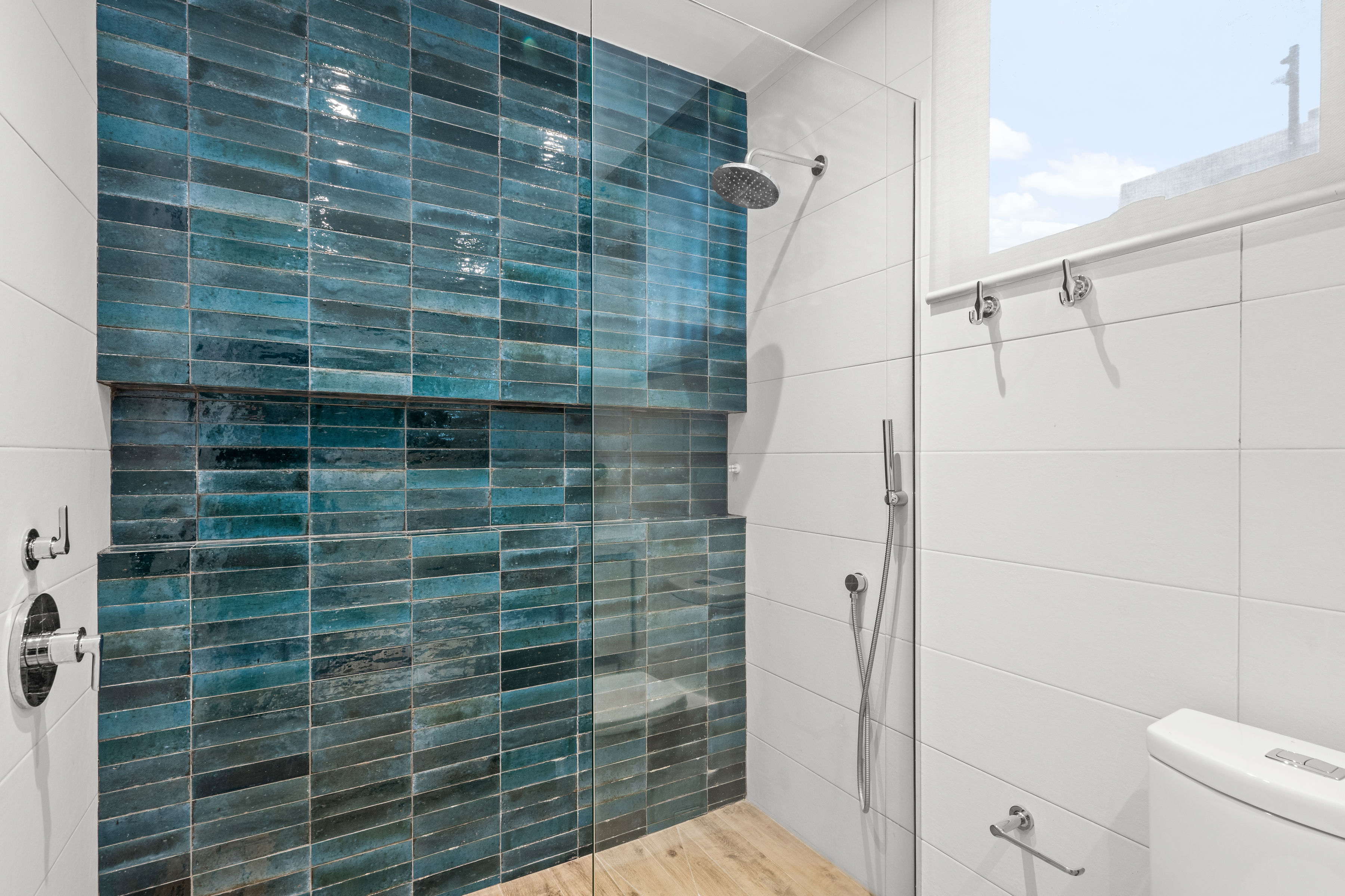 Casa Cervantes 2 | Walk-in shower with blue tile feature wall, rainfall shower, and built-in bench