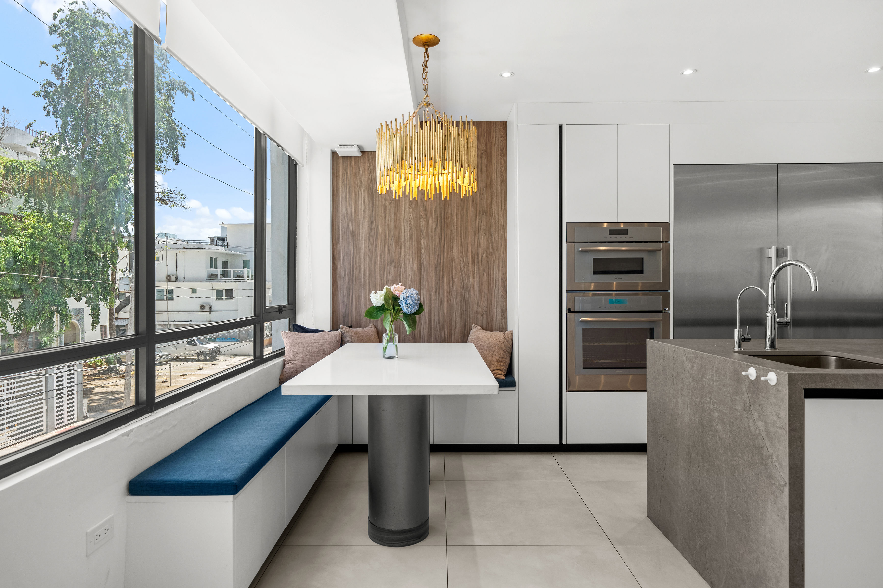Casa Cervantes 2 | Modern kitchen breakfast nook with built-in seating and expansive windows