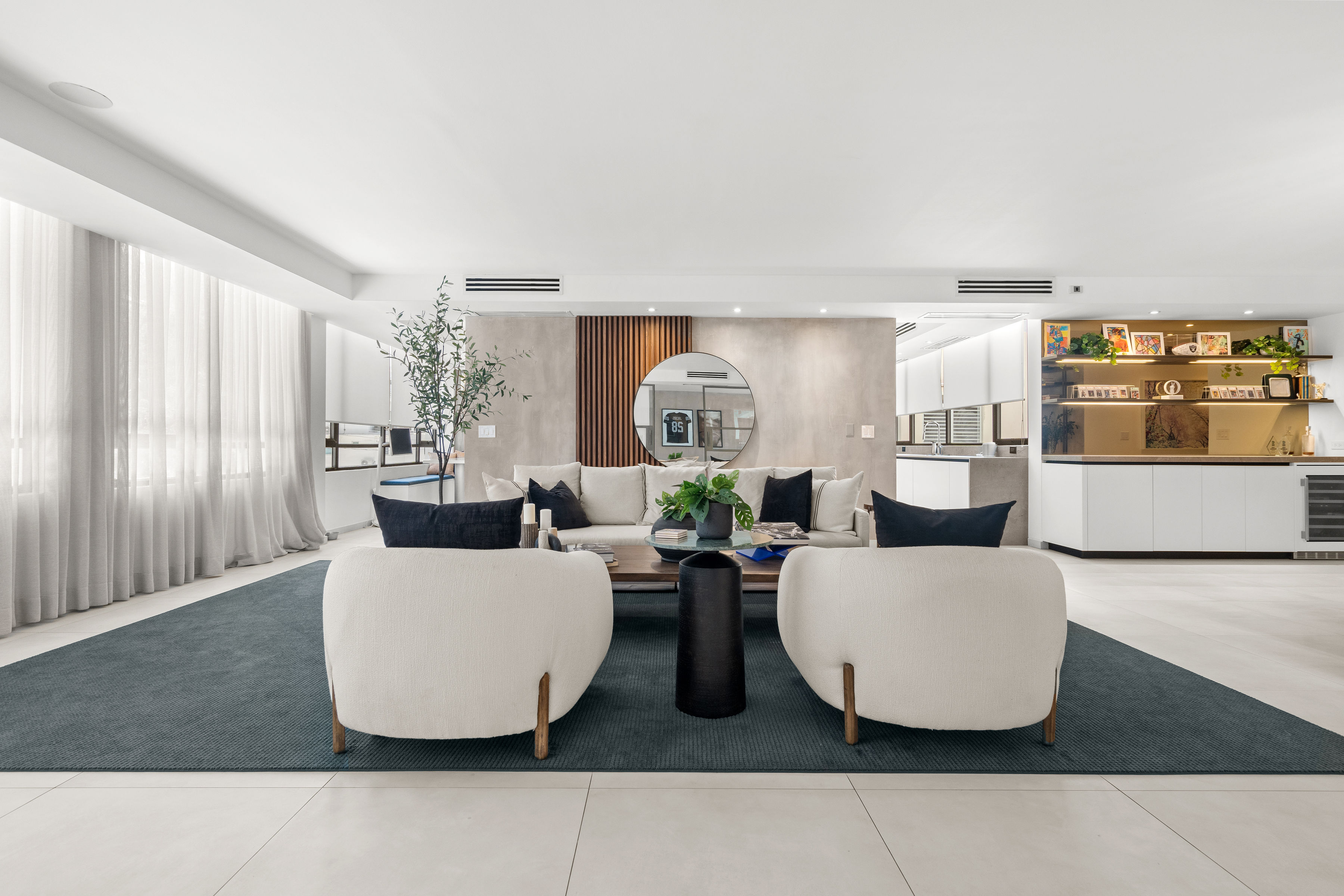 Casa Cervantes 2 | Spacious living room with large windows, custom wood accents, and contemporary furnishings