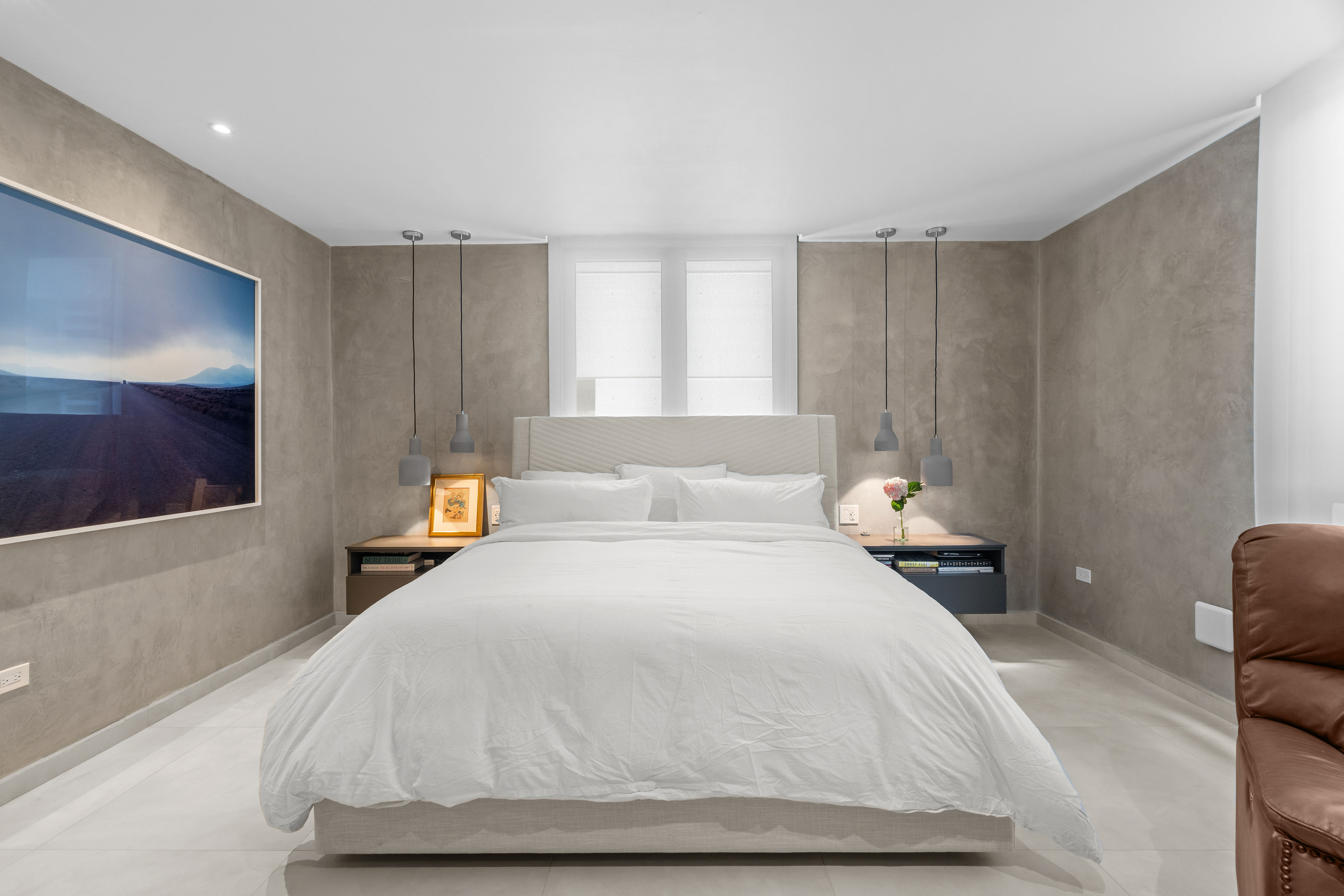 Casa Cervantes 2 | Primary bedroom with upholstered bed, custom bedside lighting, and contemporary finishes